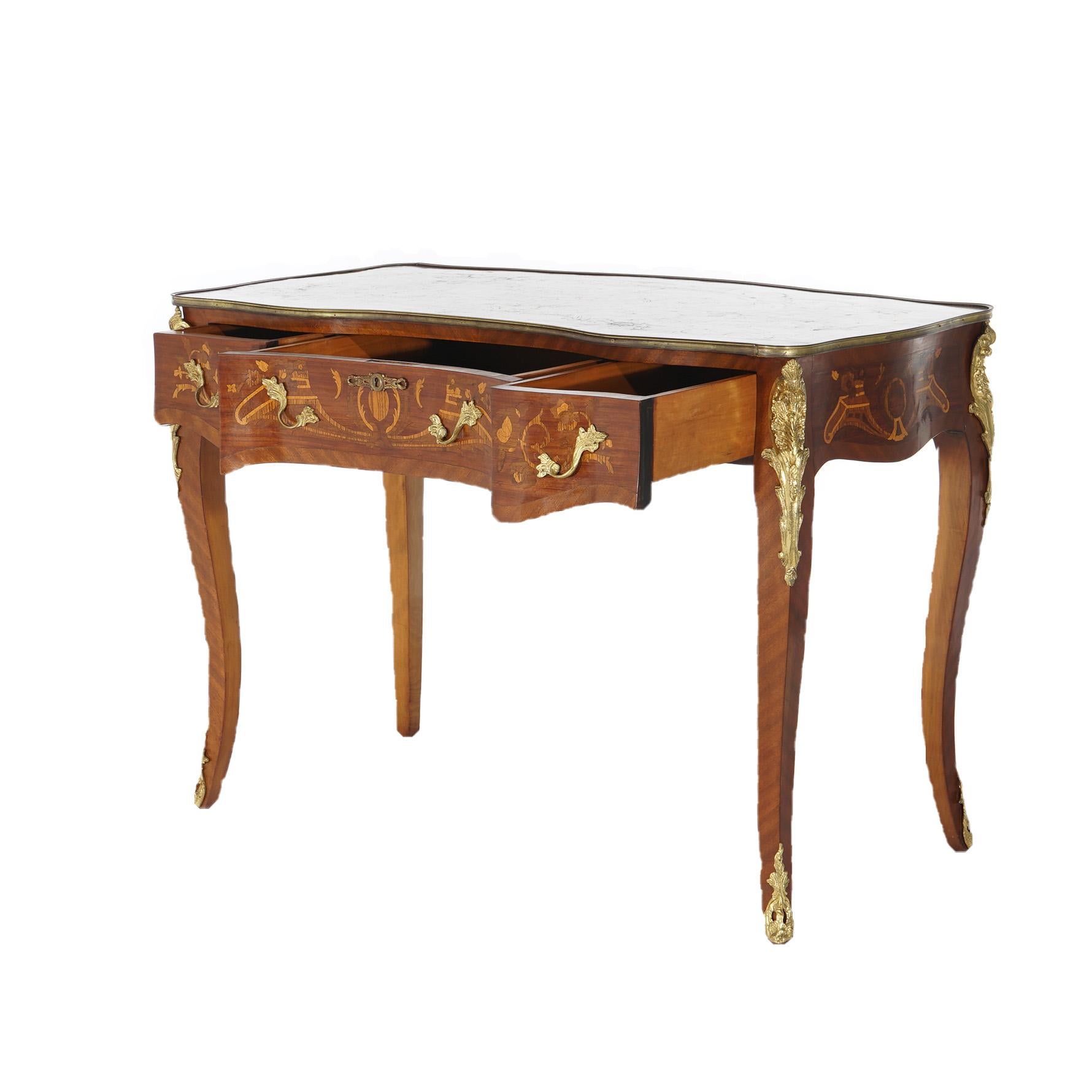 A French Louis XIV style writing desk offers kingwood  and mahogany construction with satinwood scroll and foliate marquetry throughout, three upper drawers, cast ormolu mounts and raised on cabriole legs, 20th century

Measures- 31''H x 43''W x