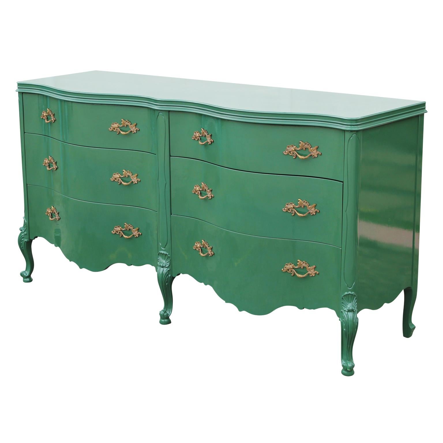 French Louis XIV lacquered green double serpentine front brass handles dresser. Circa 1930's, in the style of Baker furniture. Bold stunning look in any room. Fresh restoration.
