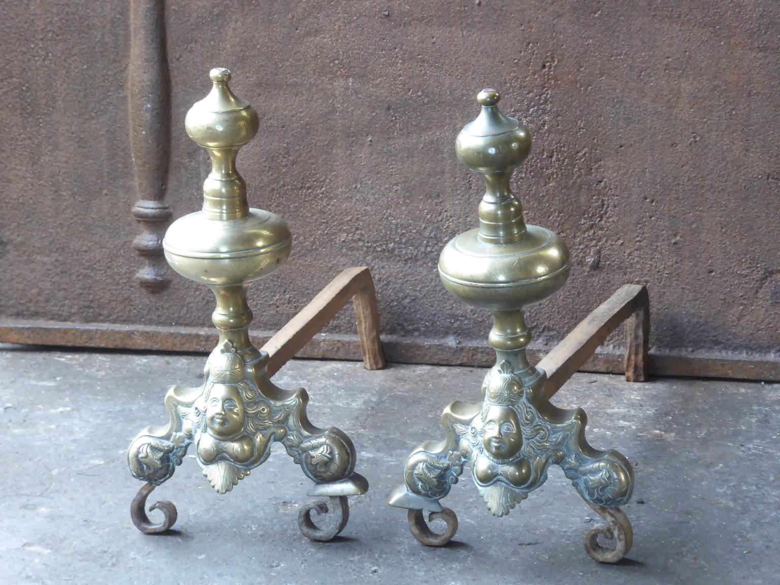 17th century French Louis XIV andirons. The andirons are made of bronze and wrought iron. They have a typical Louis XIV design which was popular during the 17th century. In France they are called marmousets, which means jesters, professional jokers