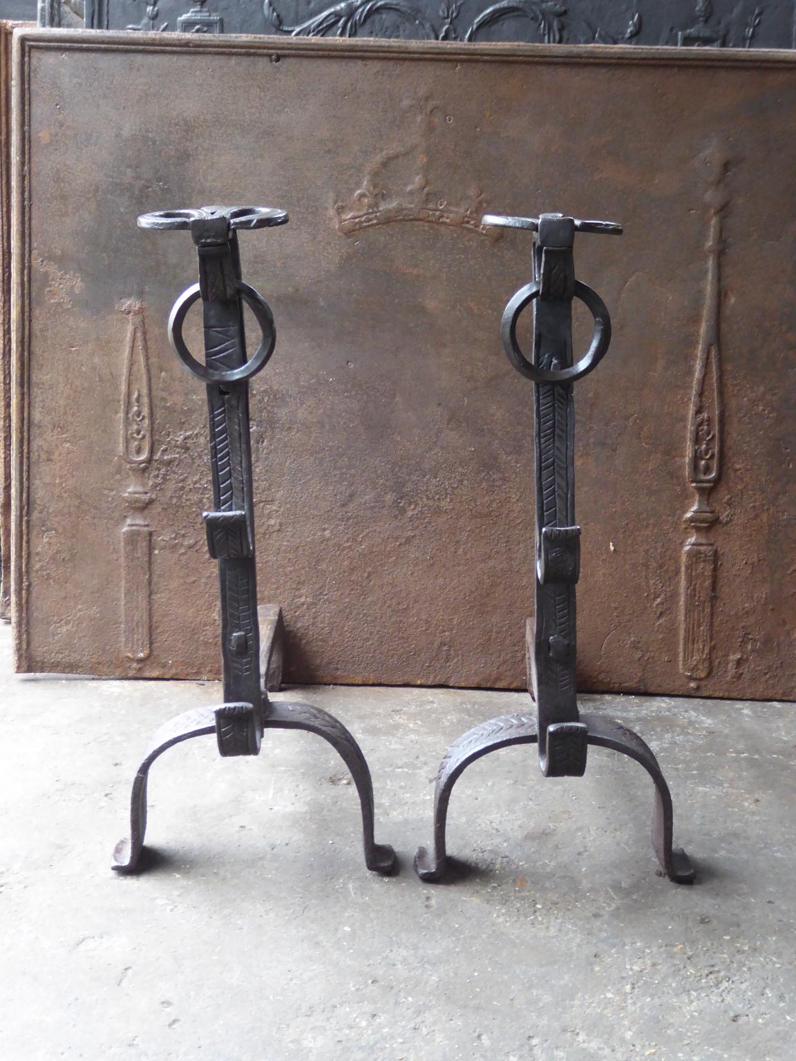 Beautiful 17th century French Louis XIV period andirons. They are hand forged and made of wrought iron. These French andirons are called 'landiers' in France. This dates from the times the andirons were the main cooking equipment in the house. They