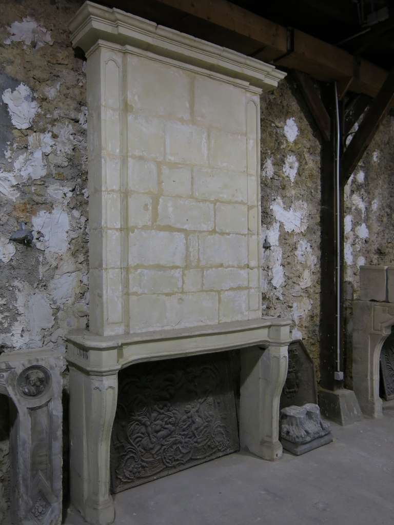 French antique fireplace Louis XIV period with original Trumeau (Top) in limestone from Paris, France 18th century.
Rare legs with 3 sides Louis XIV panels (on the front and the 2 sides of each leg). Sides of mantel advanced on the front. Rare