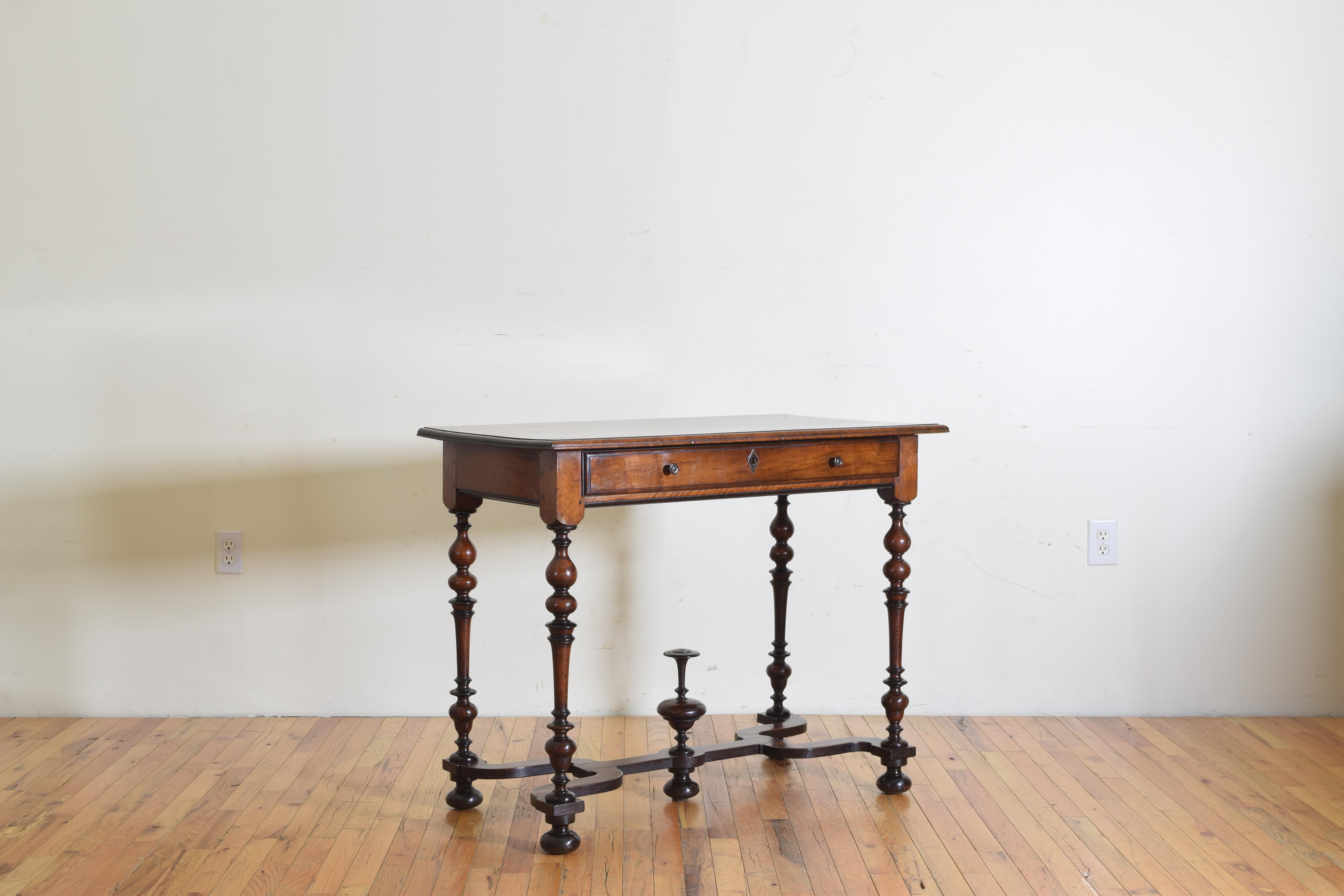 Having a rectangular top with molded edge above a conforming case housing one drawer, raised on expertly turned legs joined by a unique double Y-form stretcher centering an elaborately turned finial.