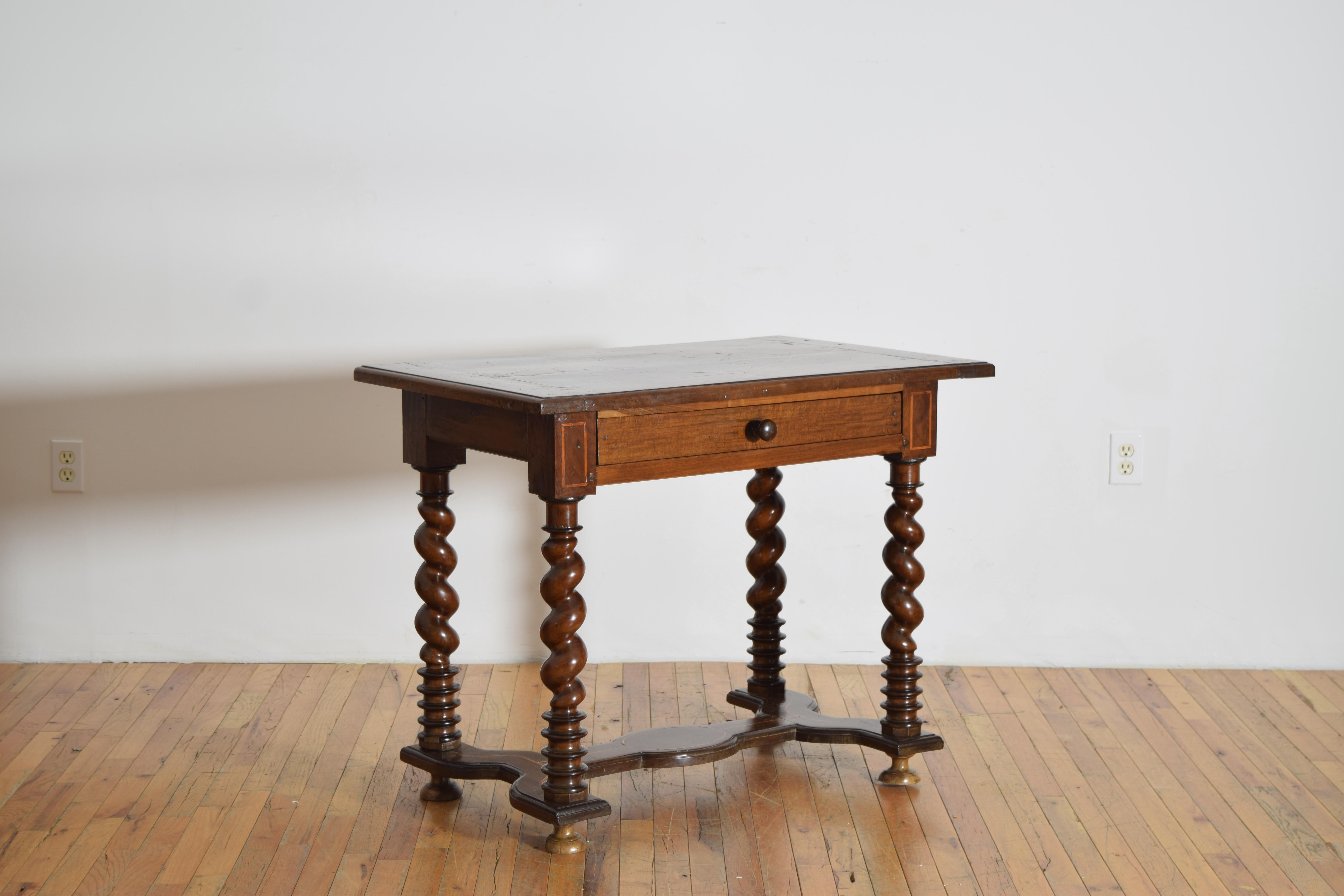 the rectangular top with molded edge and patterend line inlays above a conforming case housing one drawer, the case raised on spiral twisting turned legs, the legs joined by a shaped h-form stretcher, resting on flattened bun feet
