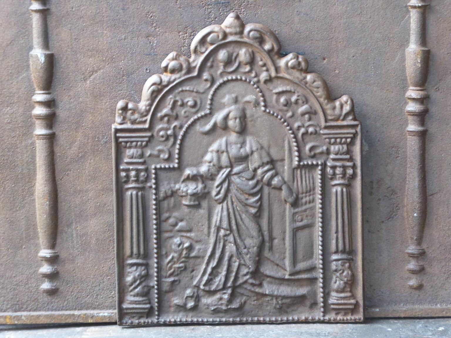 20th century French Louis XIV style fireback with an allegory of the Afternoon The fireback is made of cast iron and has a natural brown patina. Upon request it can be made black. The fireback is in a good condition and does not have