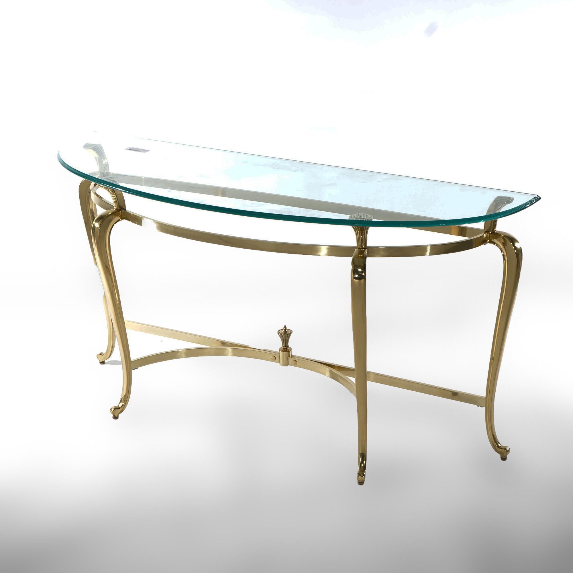 A French Louis XIV style console table offers demi-lune glass top over bronzed gilt metal base having cabriole legs terminating in stylized scroll form feet, 20th century

Measures - 27