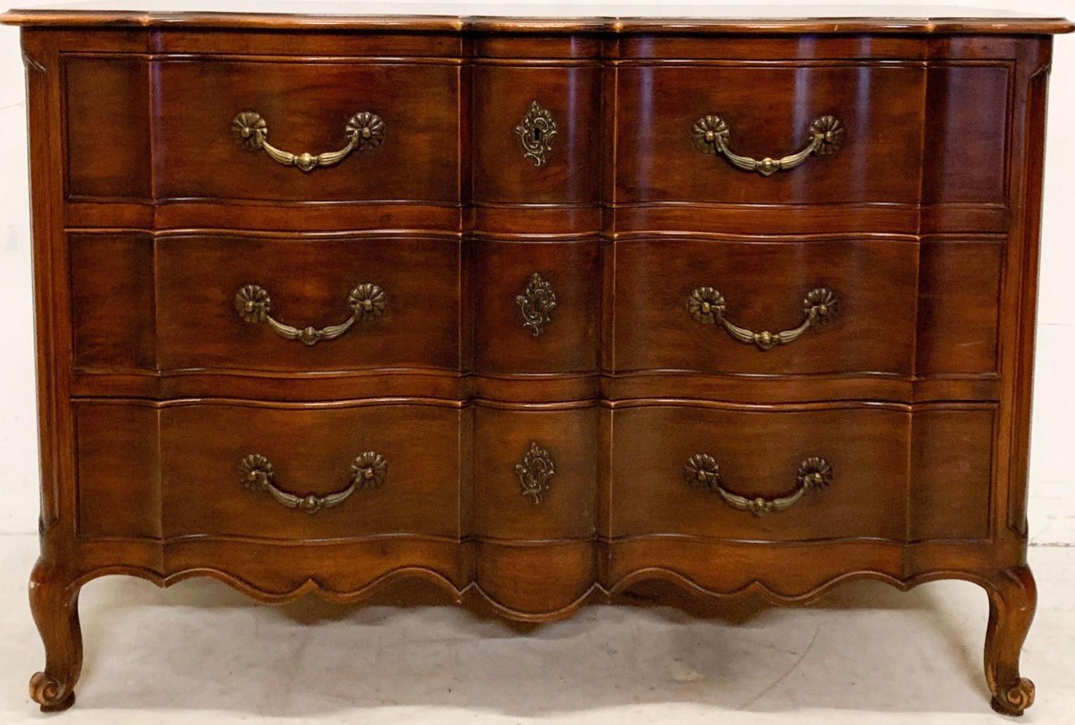 This is a versatile piece that would work from foyer to bed to bath. It is a carved French Louis XIV style carved mahogany commode designed by John Widdicomb for Ralph Widdicomb. The quality and construction are impeccable with excellent attention