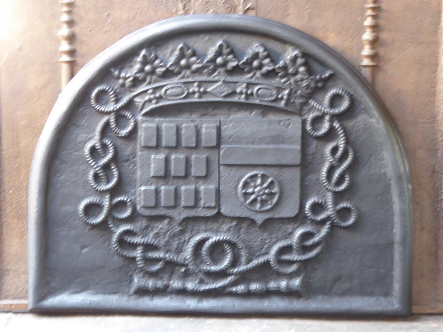 20th century French Louis XIV style fireback with the coat of arms of the De Rostaing Family, 17th century. Described by P. Palasi ('Plaques de cheminées héraldiques'; item 128)

The fireback is made of cast iron and has a black / pewter patina. The