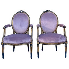 French Louis XIV Style Ebonized and Parcel-Gilt Bergère Chairs, a Pair
