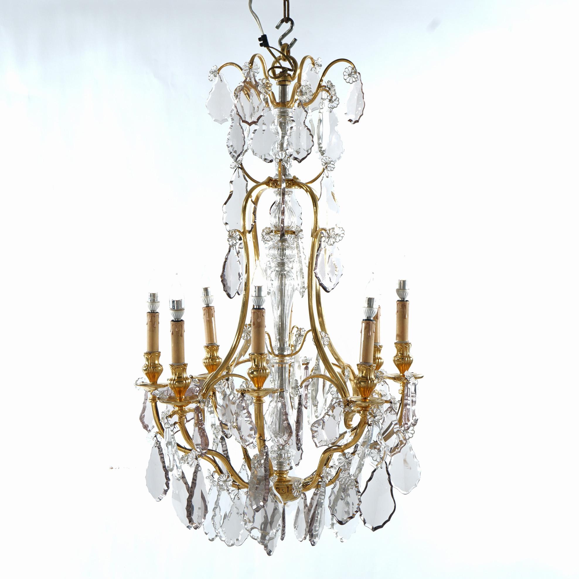 ***Ask About Lower In-House Shipping Rates - Reliable Service & Fully Insured***
A French Louis XIV style chandelier offers gilt bronze frame with eight scroll form arms terminating in candle lights, cut crystals throughout, 20th century

Measures -