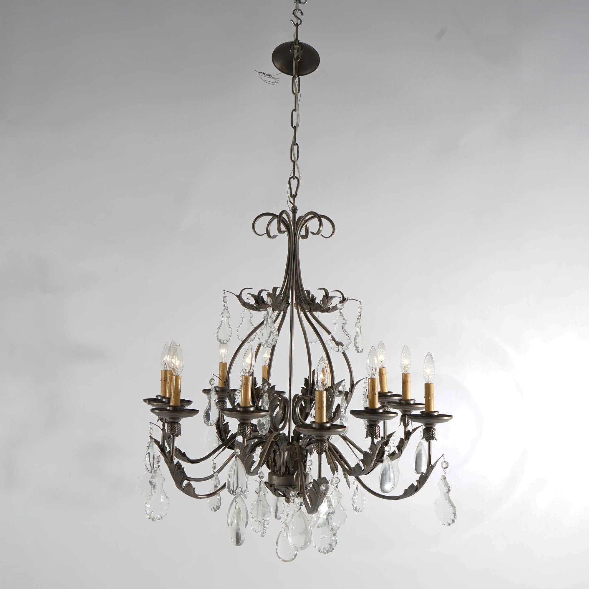 A French Louis XIV style chandelier offers gilt metal frame with scroll form arms terminating in candle lights; foliate elements and cut crystals throughout; 20th century

Measures - 51