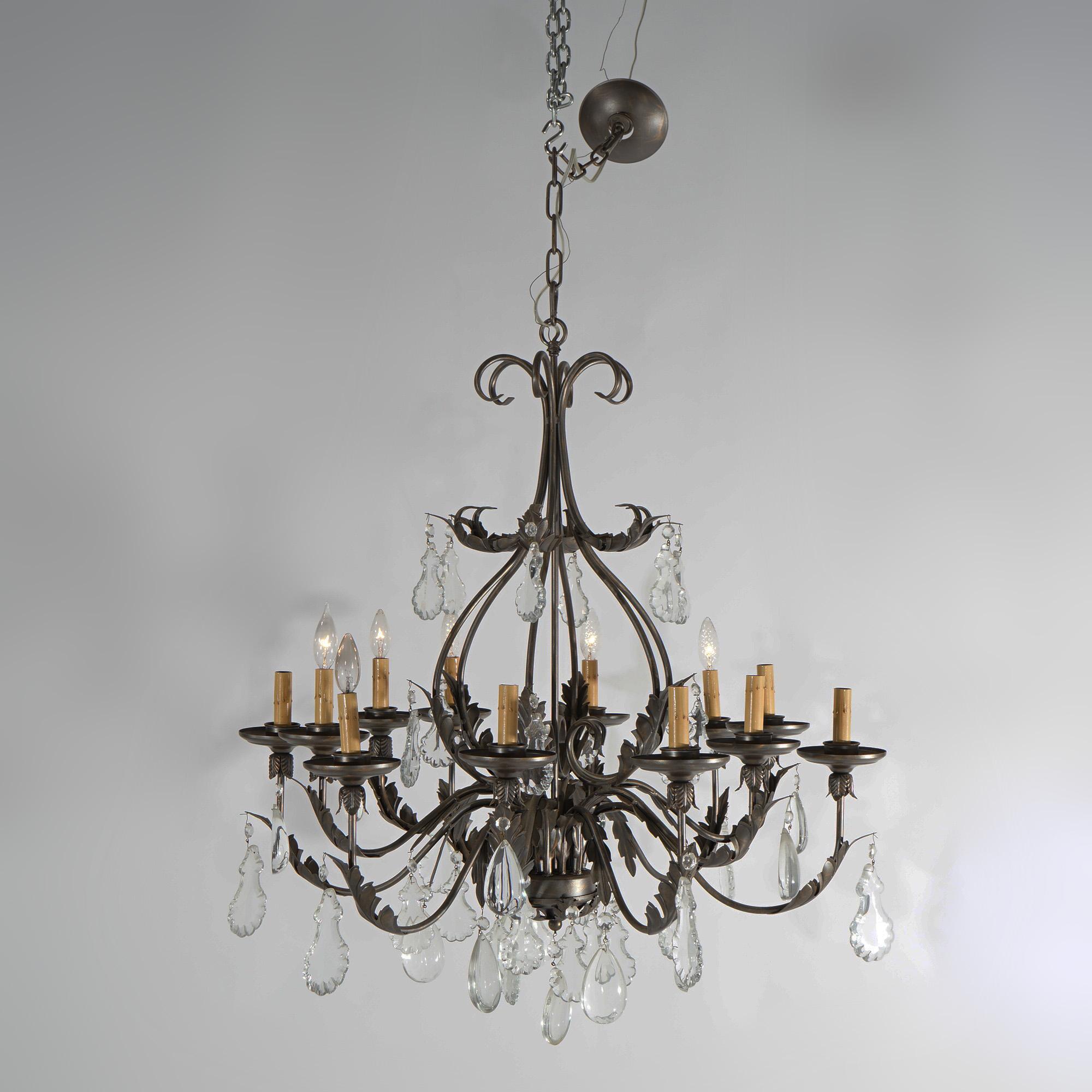 A vintage French Louis XIV style chandelier offers gilt metal construction with twelve scroll and foliate form arms terminating in candle lights, cut crystal highlights throughout, 20th century

Measures - 51