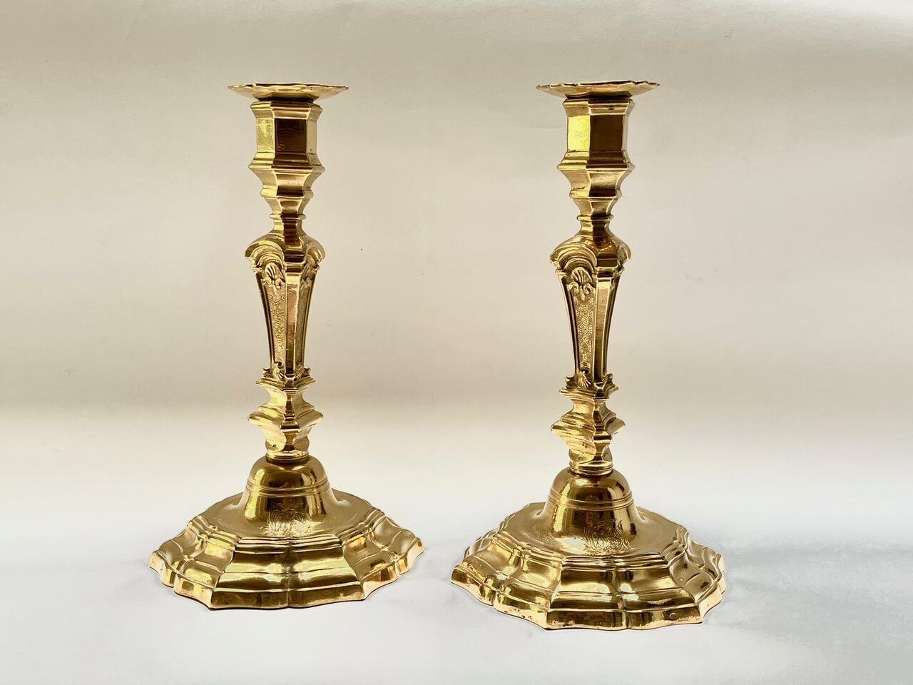 A beautiful and fine pair of French, circa 1840 Louis Philippe period, Louis XIV baroque revival style finely cast ormolu or fire-gilded solid bronze (bronze doré) candlesticks having original removable bobeches and engraved royal armorials or