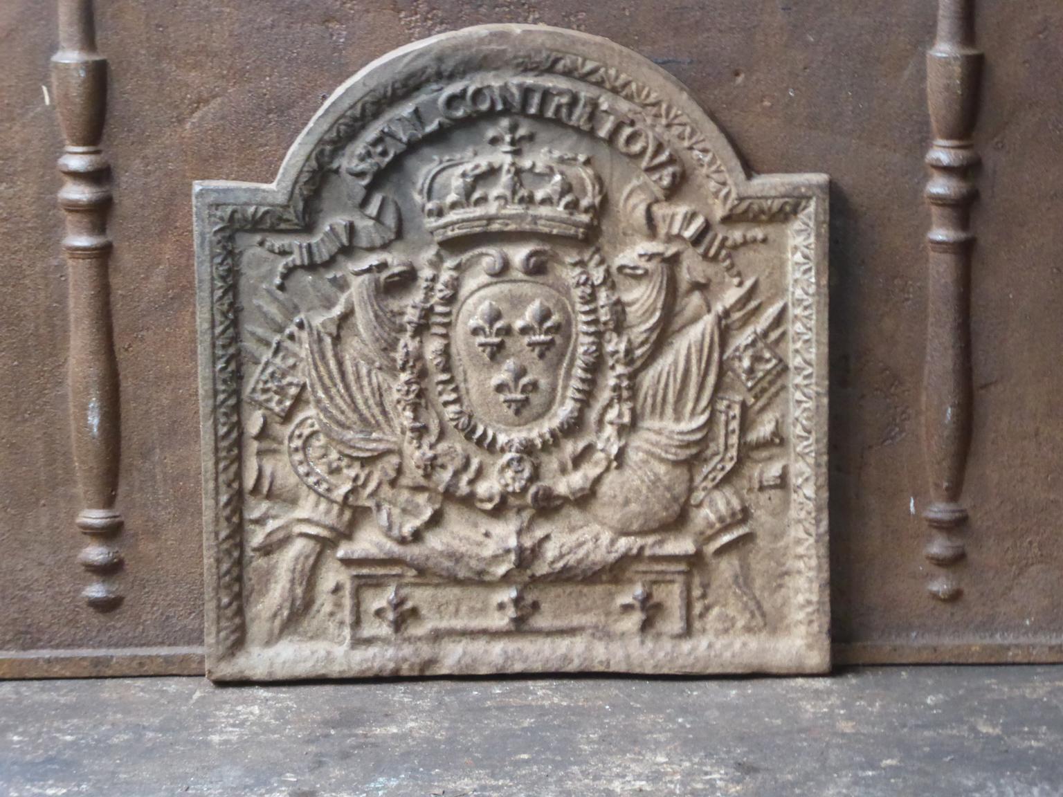 French Louis XIV style fireback with the arms of France and the inscription 'Seul contre Tous or 'All against One'. It symbolizes the French battle against the European coalition at the end of the 17th century. The coalition tried to restrict the
