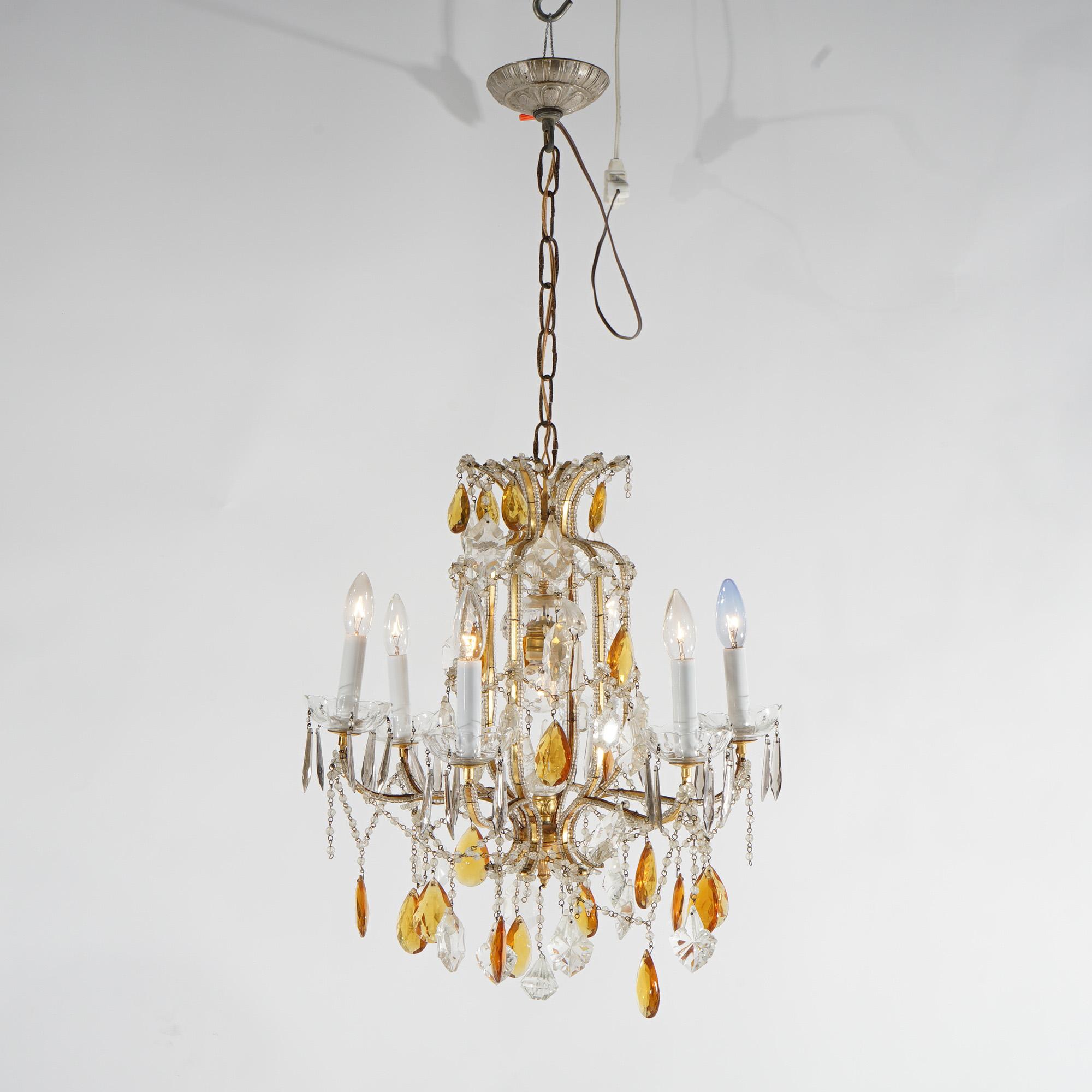 A French Louis XIV style chandelier offers gilt metal scroll form frame with seven candle lights; strung, cut and amber prisms throughout, 20th century

Measures - 37