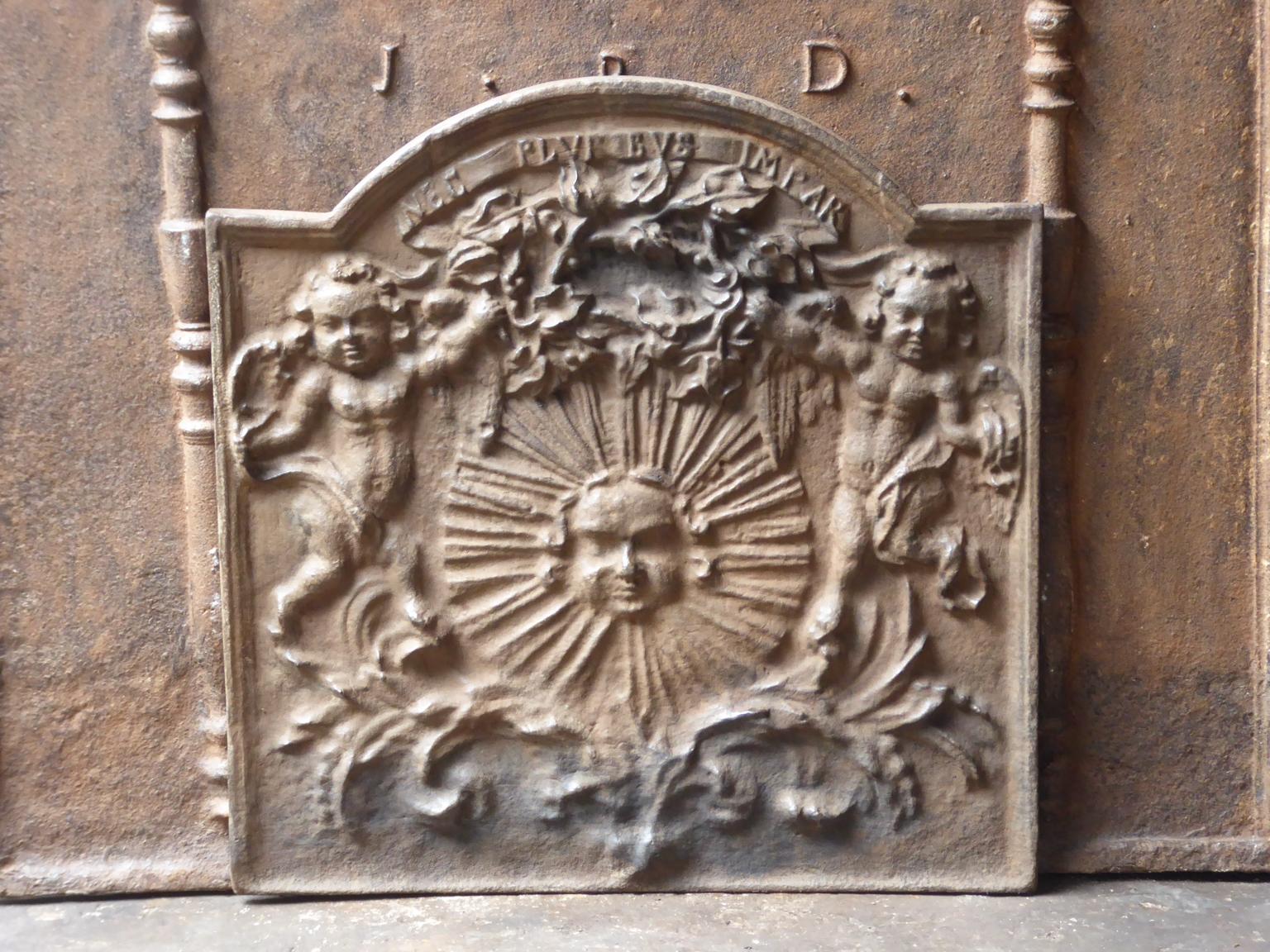 With the sun representing Louis XIV, the Sun King. 20th century Louis XIV style.

The fireback is made of cast iron and has a natural brown patina. Upon request it can be made black / pewter. The fireback is in a good condition and does not have