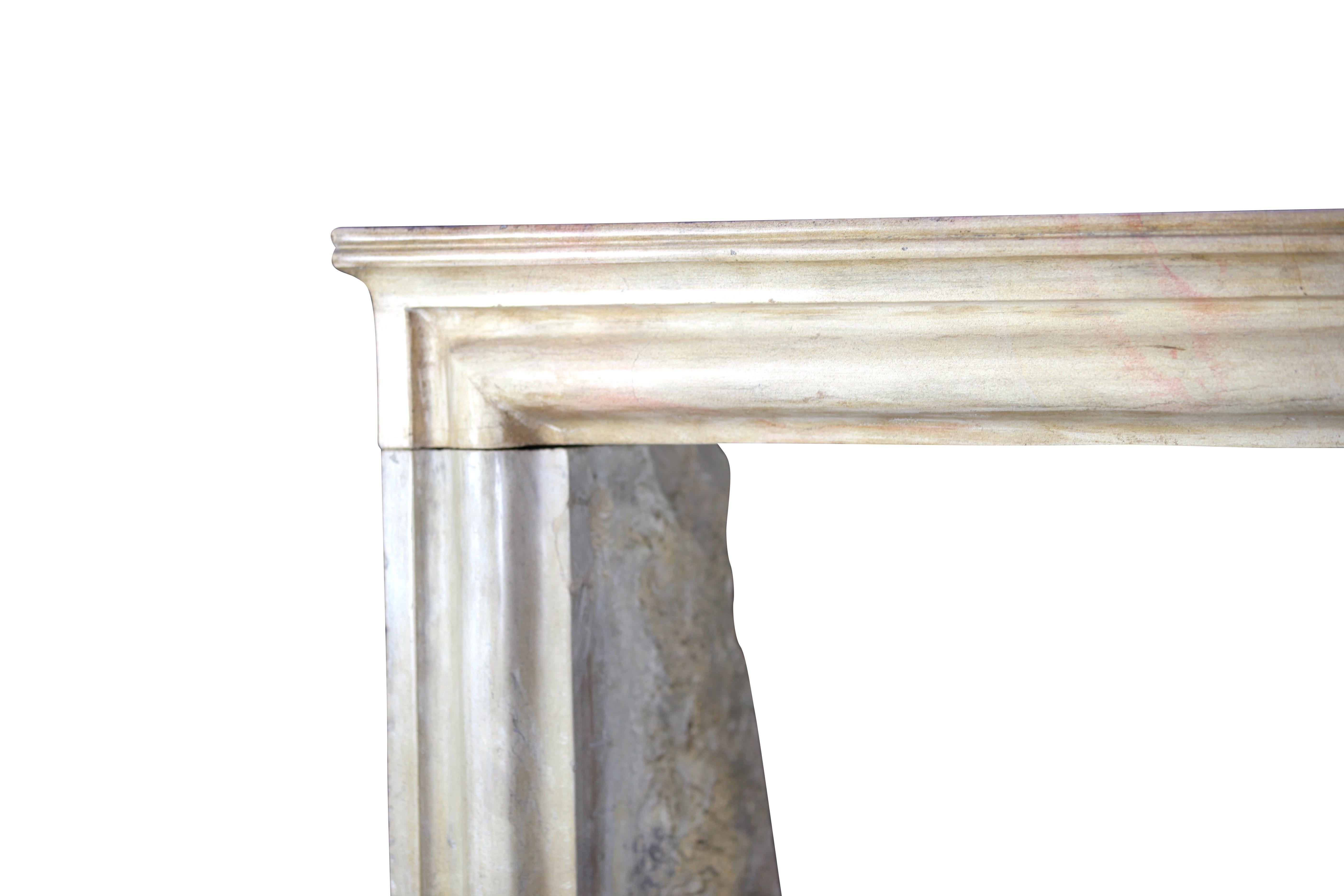 A French timeless Louis XIV style vintage fireplace surround from the 19th century. It is made in a honey color Burgundy hard stone/marble which has been polished.
Measures:
113 cm exterior width 44.49 inch
105 cm exterior height 41.33 inch
89