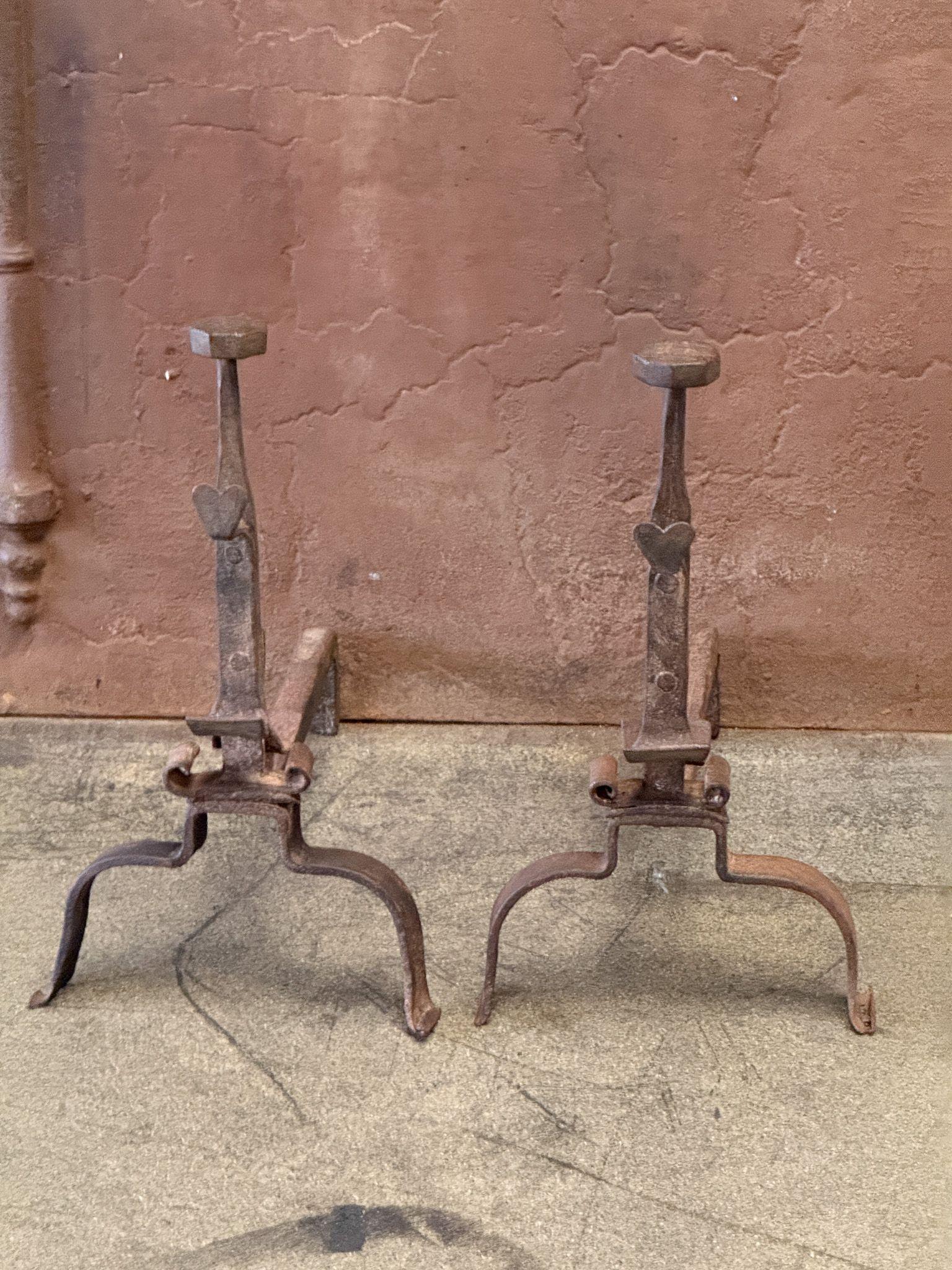 18th century French andirons made of wrought iron. The andirons have spit hooks to grill food. The condition is good. Style: Louis XV Period.