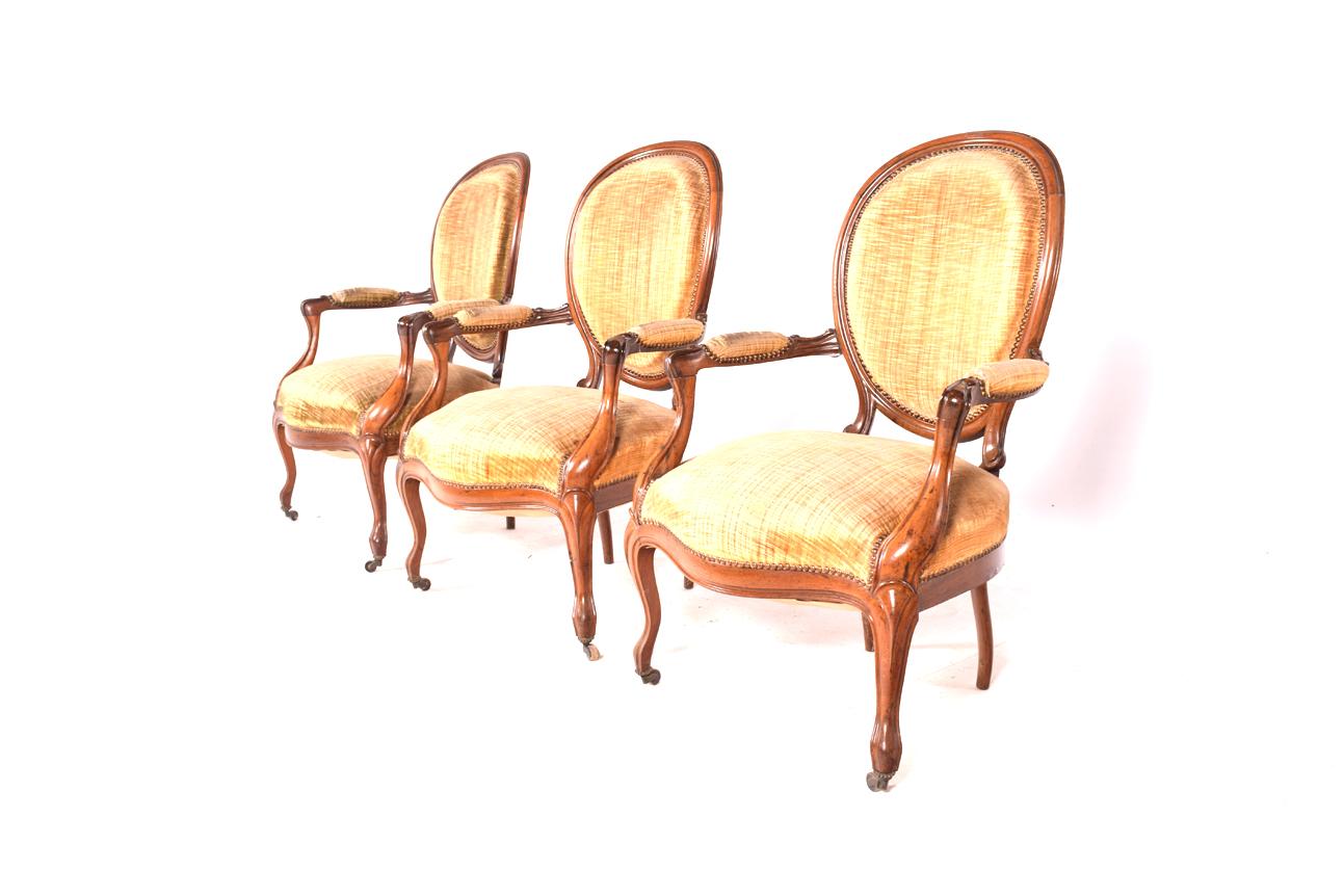 These lounge chairs have round backs. Made of finely carved walnut wood. The seats rest on curved legs. The state of conservation is good, all the woods are original.