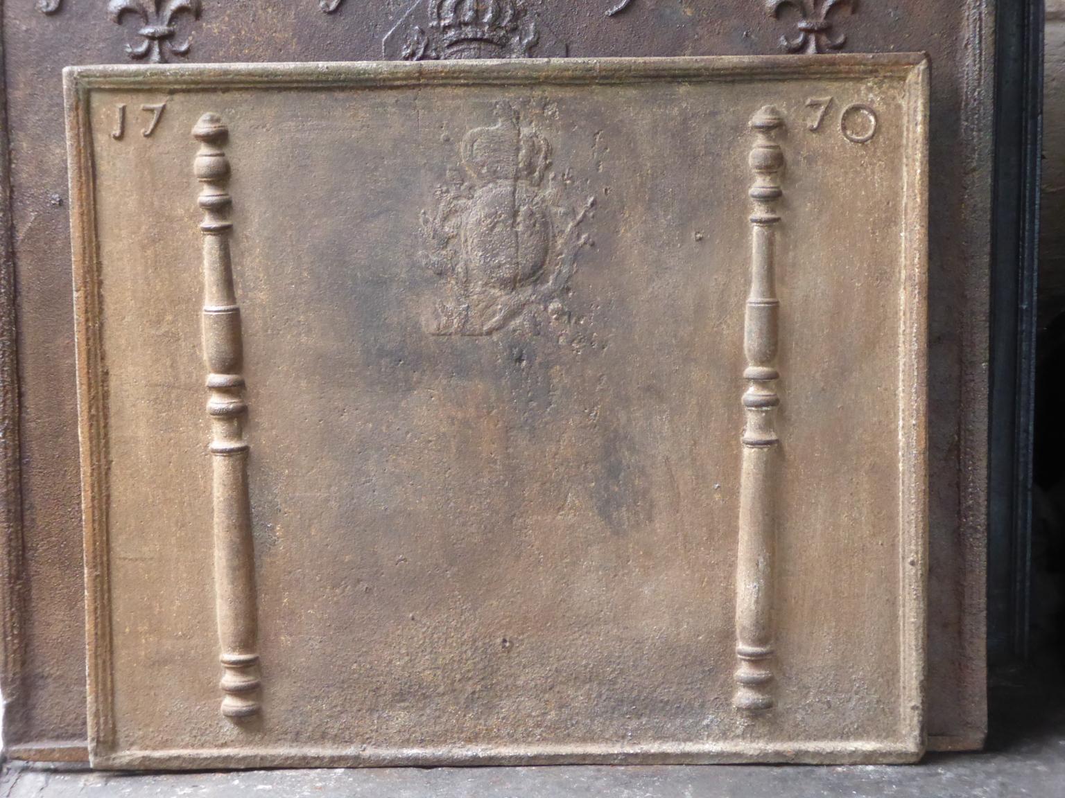 Beautiful 18th century French Louis XV fireback with the arms of France. The Arms of France are flanked by two Pillars of Hercules, which symbolize strength and the unknown. The date of production of the fireback, 1770, is also cast in the fireback.