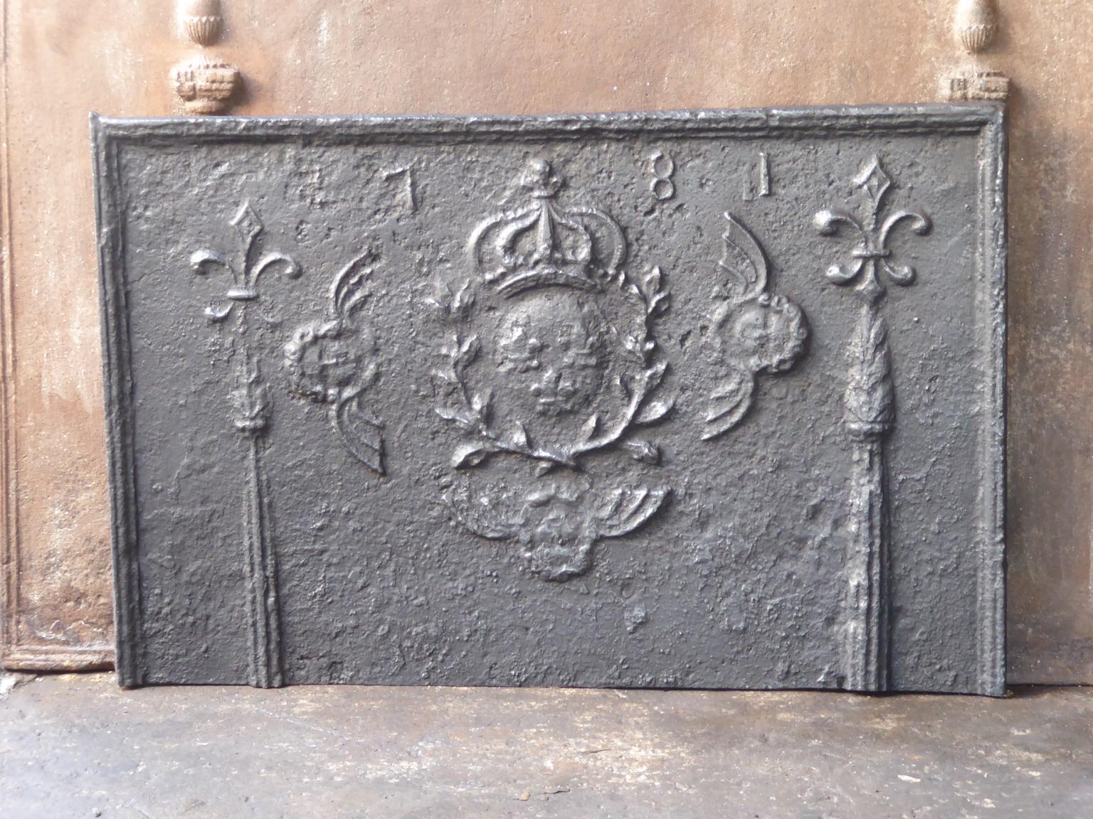 18th century French Louis XV fireback with the arms of France. The arms of France are flanked by two Pillars of Hercules, which symbolize strength and the unknown. The pillars are topped by fleurs-de-lis (French Lillies) which stand for purity and
