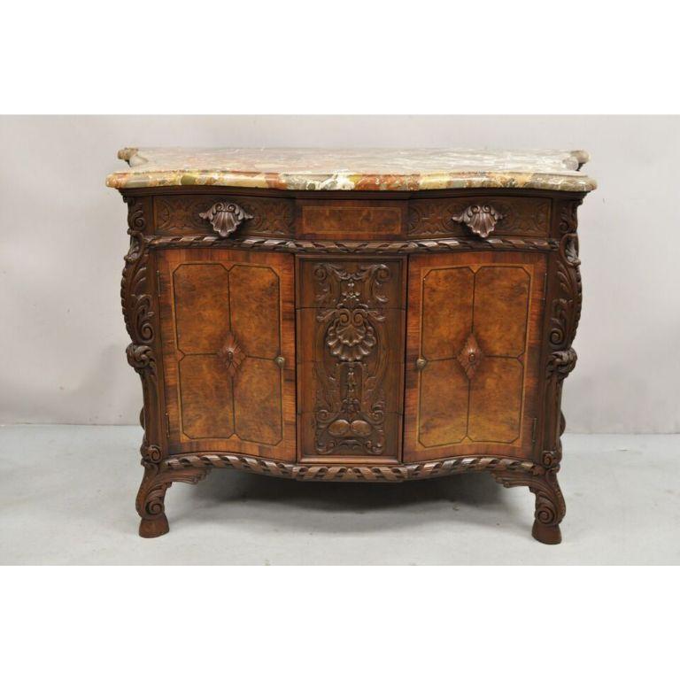French Louis XV Baroque Style Carved Burl Walnut Rouge Marble Top Commode Server. Item features 5 dovetailed drawers, remarkable shell and leafy carvings throughout, rouge marble top, 2 swing doors, very nice antique French chest of drawers. Circa