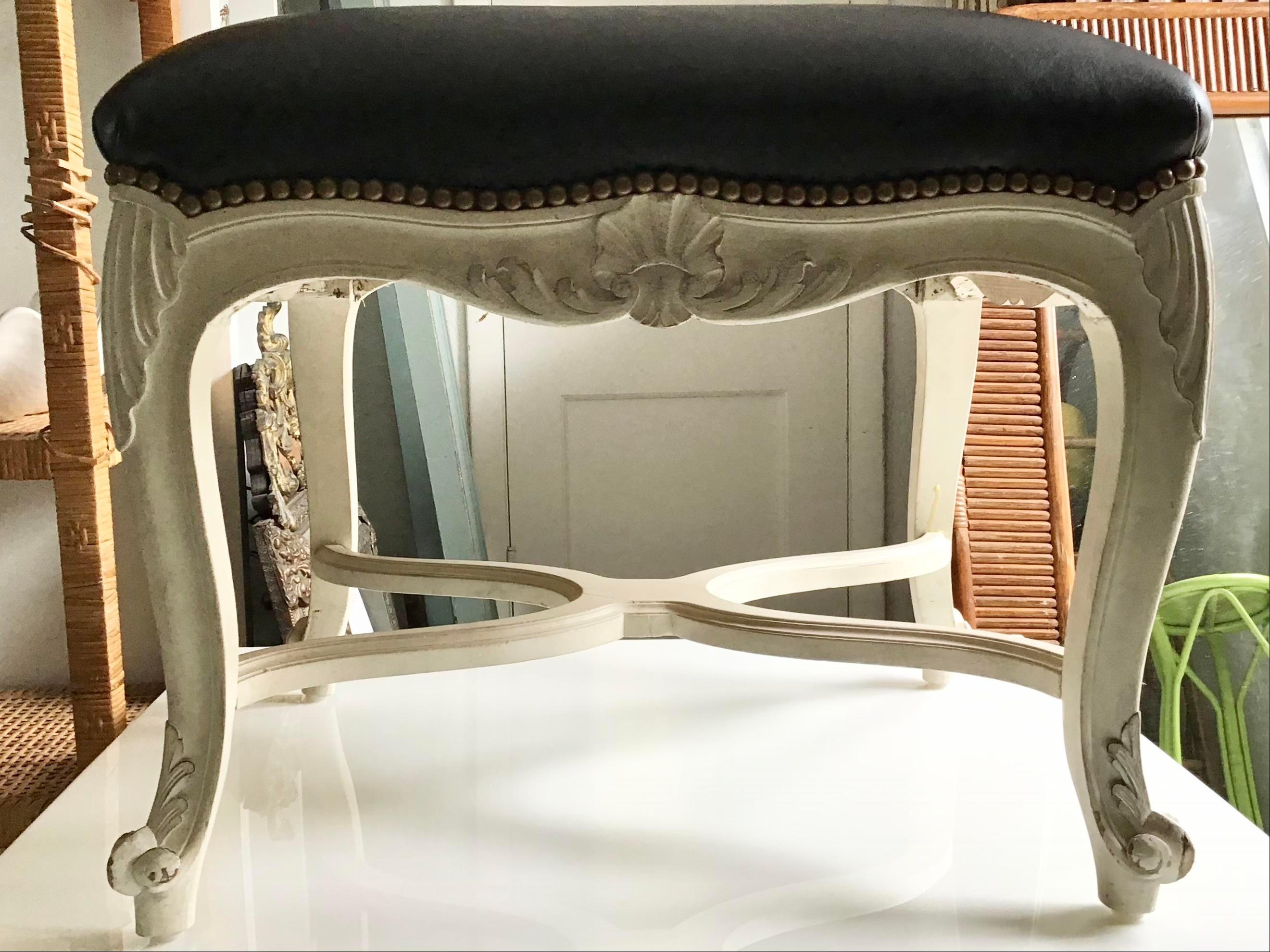 Gorgeous French Louis XV ottoman with black leather upholstery. Great carving details and original soft grey painted finish. Add some French style to your home with this accent French bench.