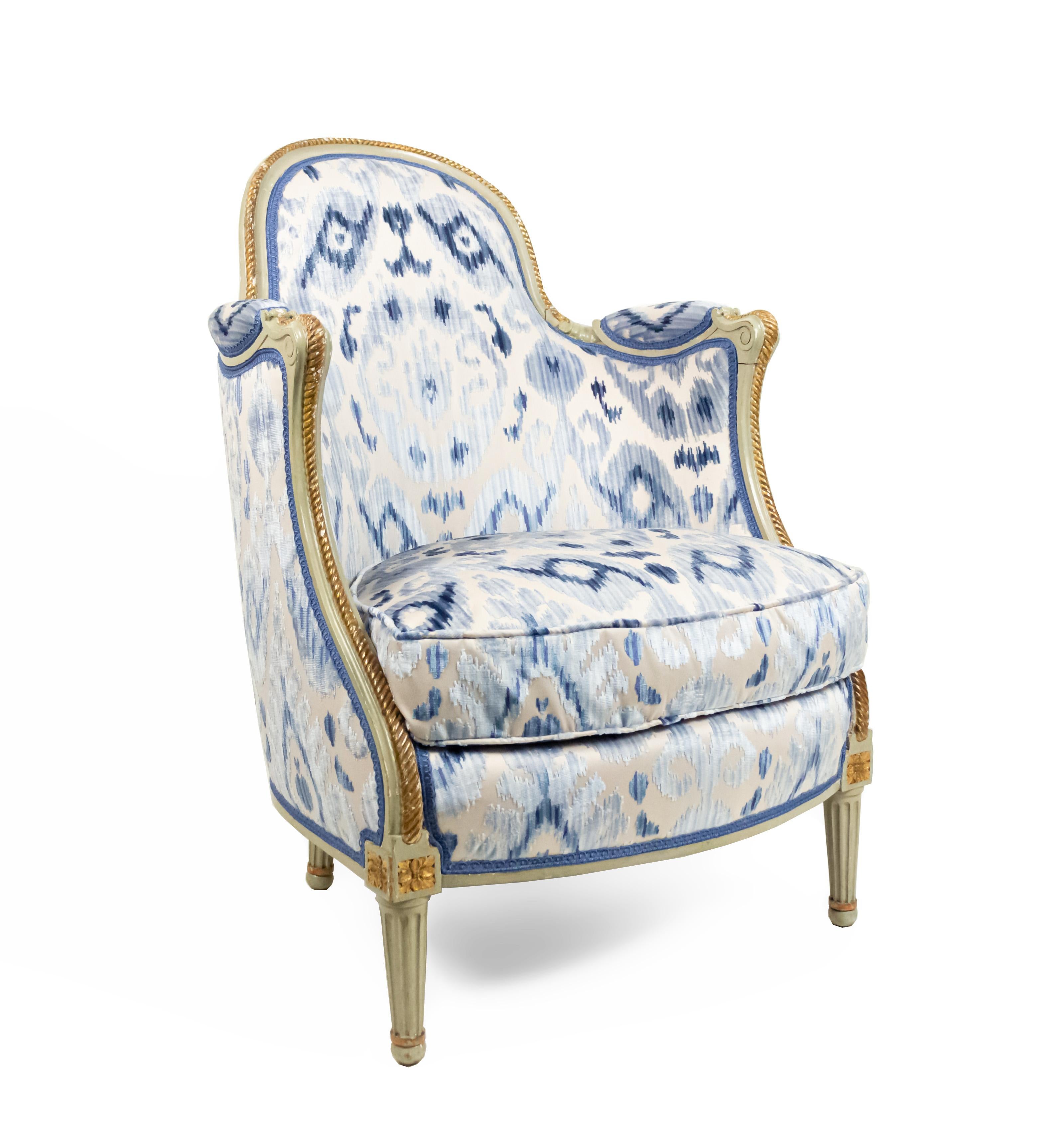 Pair of French Louis XV-style (19th Century) green painted and gilt rope carved trimmed bergere Armchairs with Ikat-style blue cut velvet and beige satin upholstery. (PRICED AS Pair)
