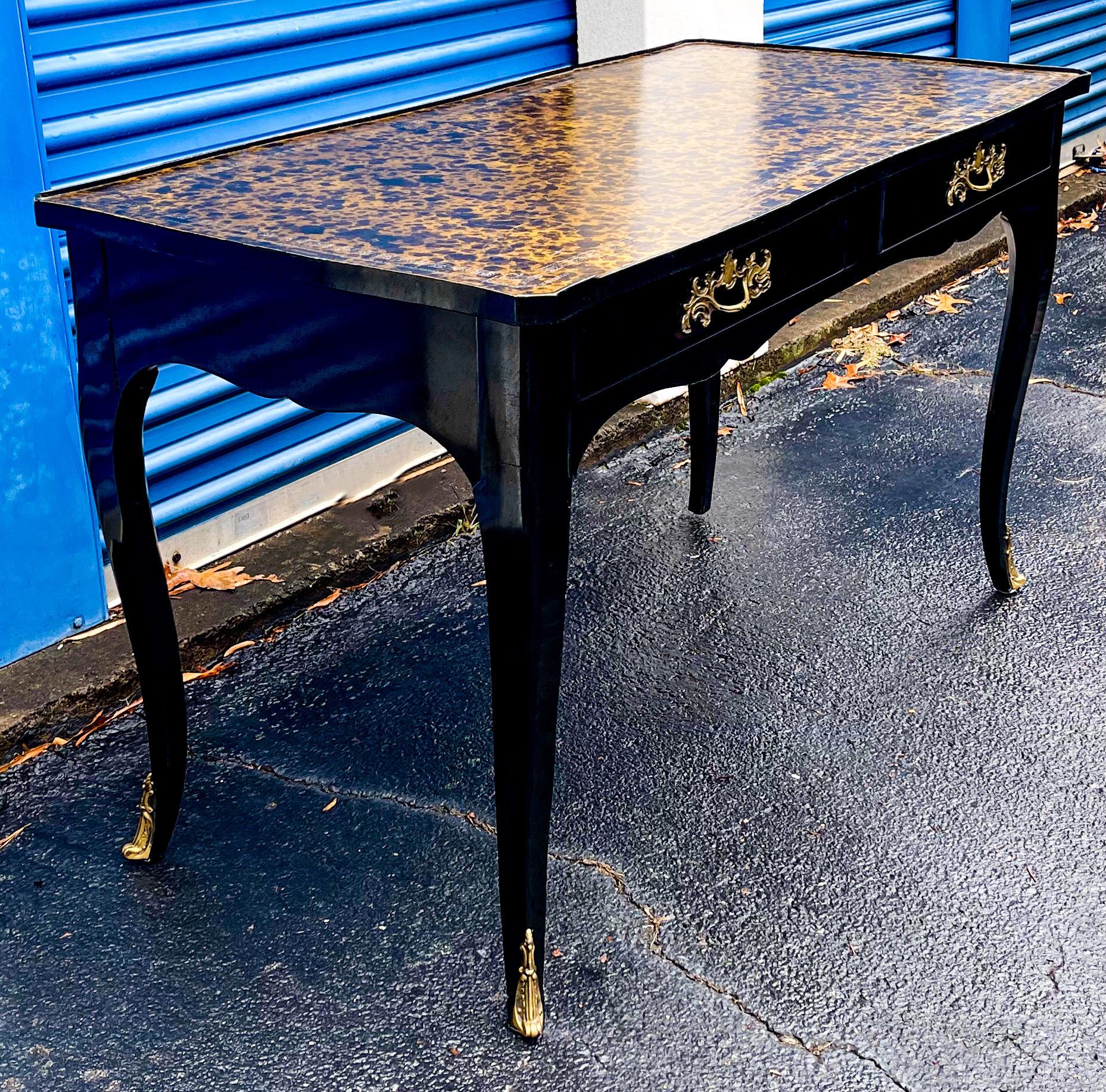 French lines and lacquer were made for each other! This is a handsome French style Louis XV black lacquered / ebonized desk by Jacques Bodart. The top is a tooled leather faux tortoise! It is marked and has dovetail construction. The ornate hardware