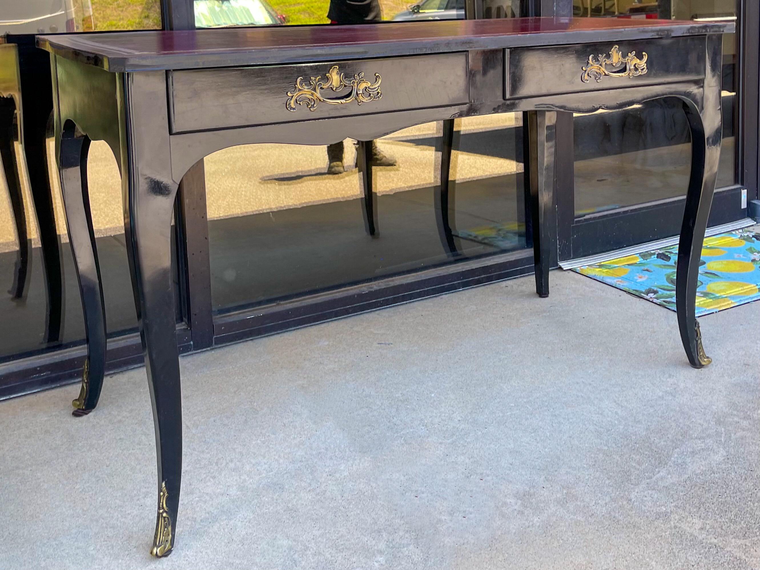 This is a handsome French Louis XV style black lacquered / ebonized desk by Jacques Bodart. The desk has a tooled red leather top and bronze appointments. It is marked. 

My shipping is for the Continental US only.