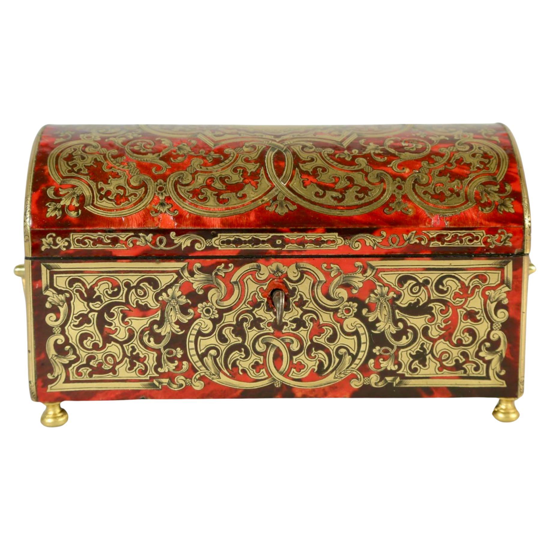 19th century French Louis XV Boulle Box By Tahan Of Paris. Dome shaped rectangular hinged box is veneered in red and gold faux tortoiseshell with brass accessories. Interior is lined in gold silk. The gilt lock plate is hand-engraved 