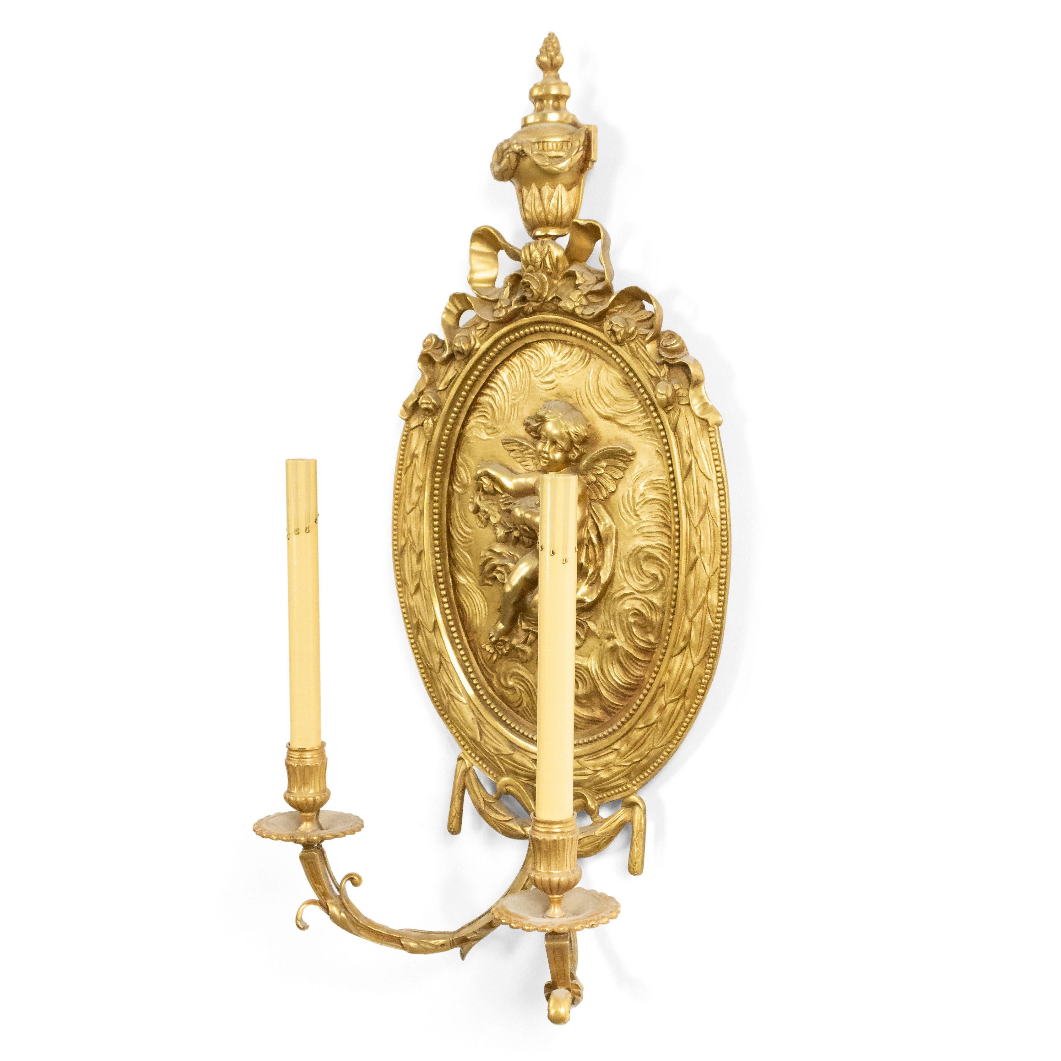 Pair of French Louis XV (19th century) bronze doré 2 arm wall sconces with oval plaque back with cupids in relief and finial top.