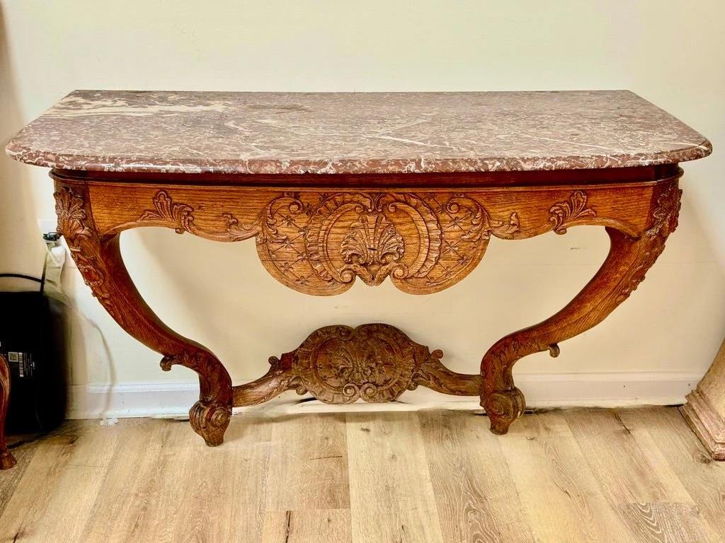 French Louis XV Carved Oak Console with Marble Top, Circa 1750. A boldly carved Louis XV console table in oak, retaining its original shaped rouge royal marble top, France, circa 1750. The serpentine apron features finely detailed shell and trellis