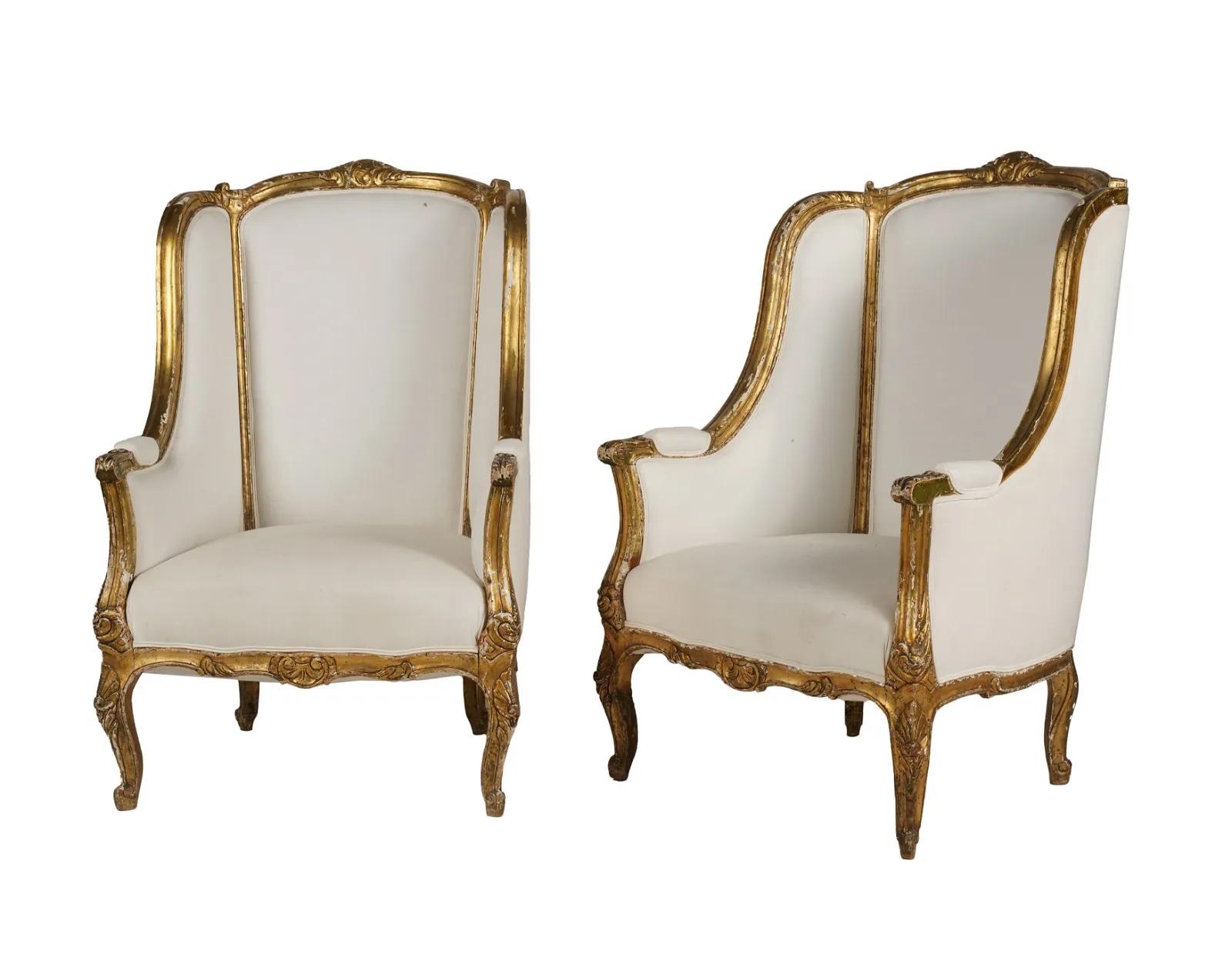 Mid 19th Century French Louis XV Carved Giltwood High Back Bergeres recently covered in white fabric upholstery. 8 way hand tied coil spring foundation. 