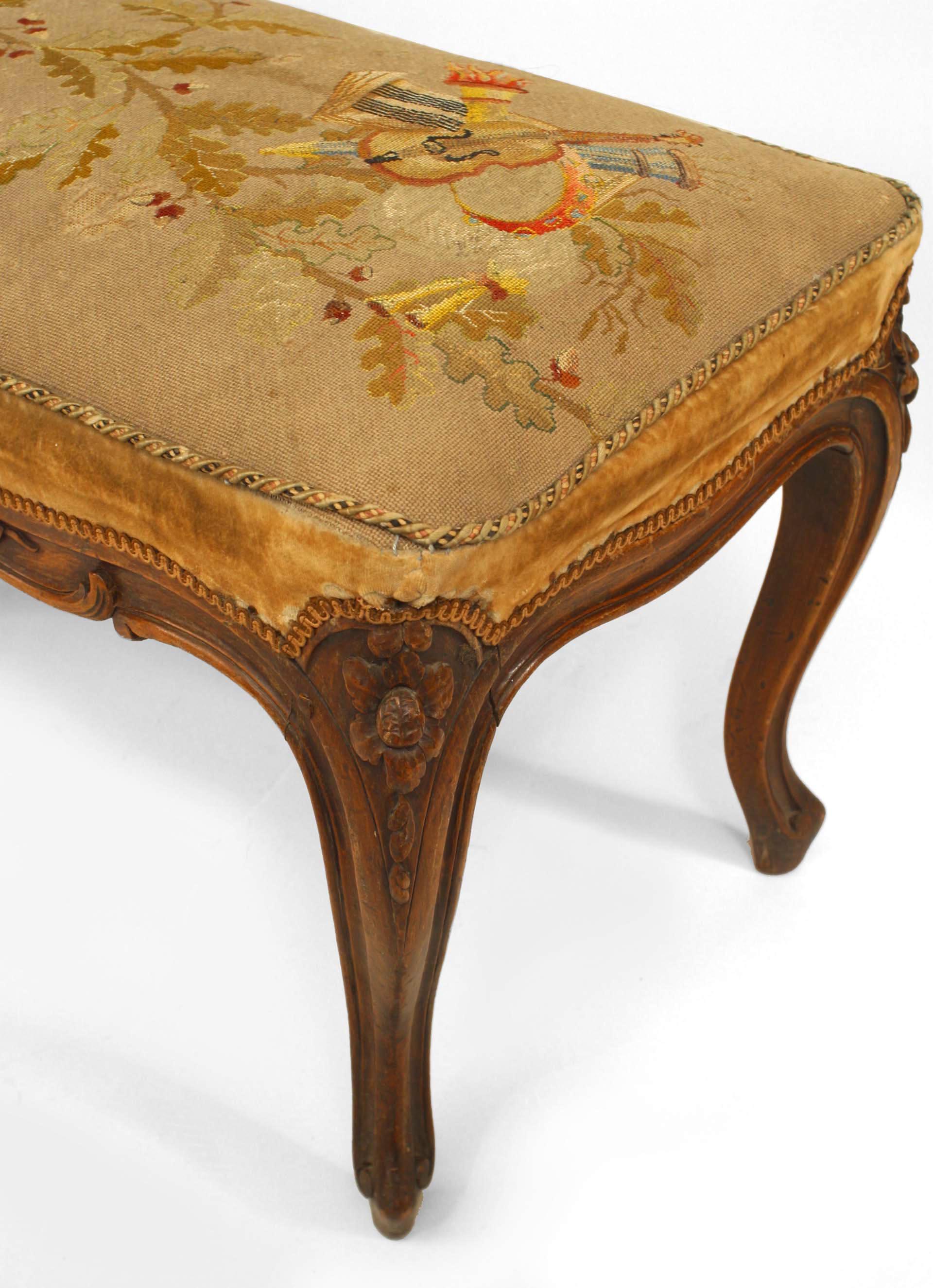 French Louis XV (18th century) narrow walnut carved bench with a tapestry upholstered seat.