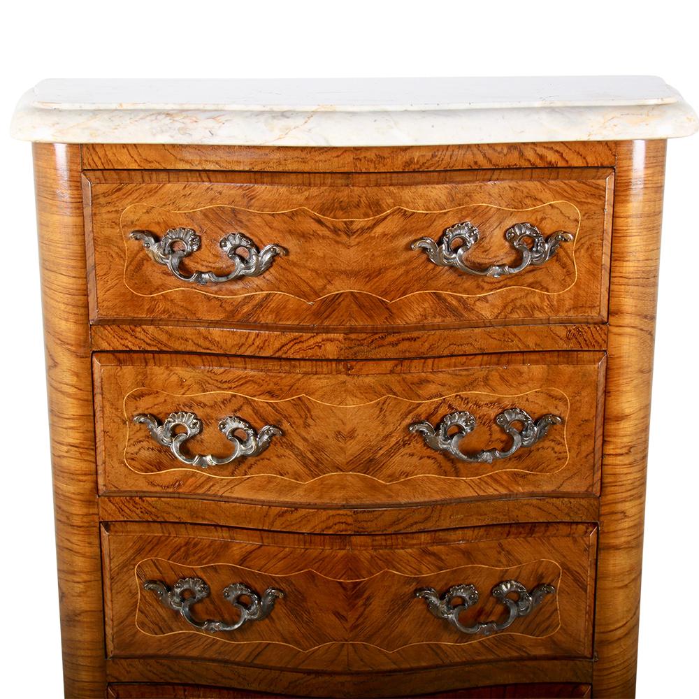 A smaller French inlaid kingwood Louis XV style five-drawer chest or commode with original shaped marble top.

     