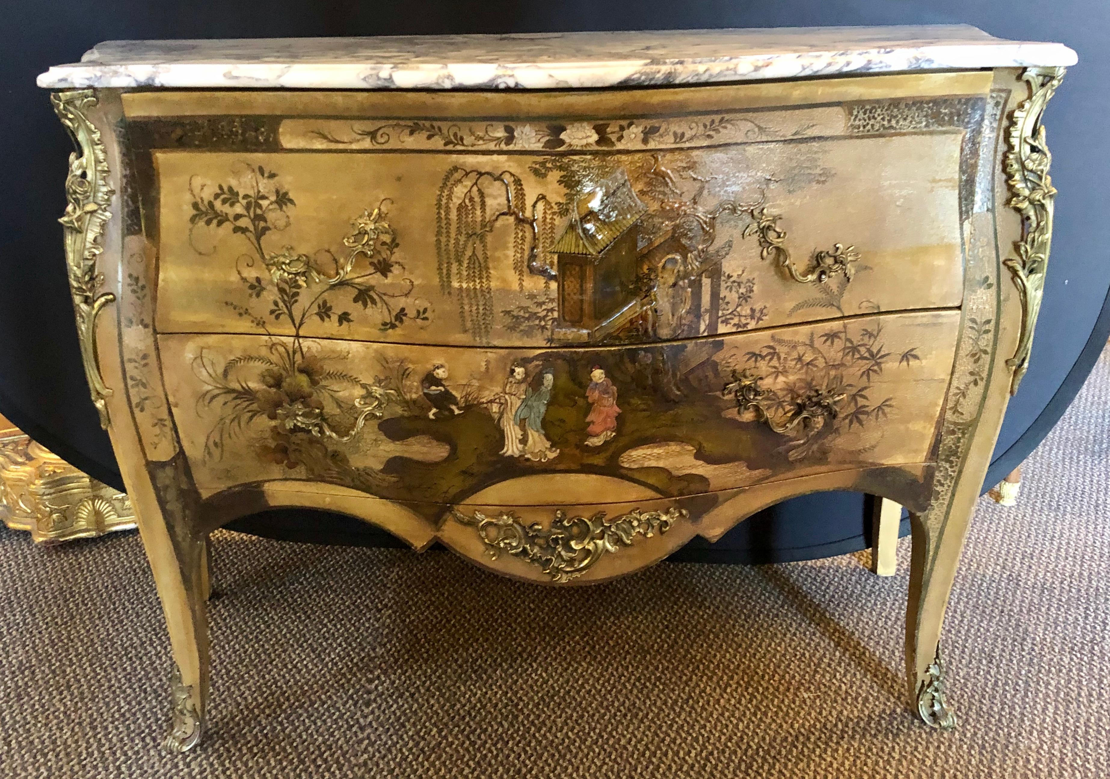 French Louis XV chinoiserie Commode. Having a Bombe form and white with gray and black veined marble top this finely crafted commode or dresser is simply stunning. The case with finely painted raised carved figures of men and woman with their