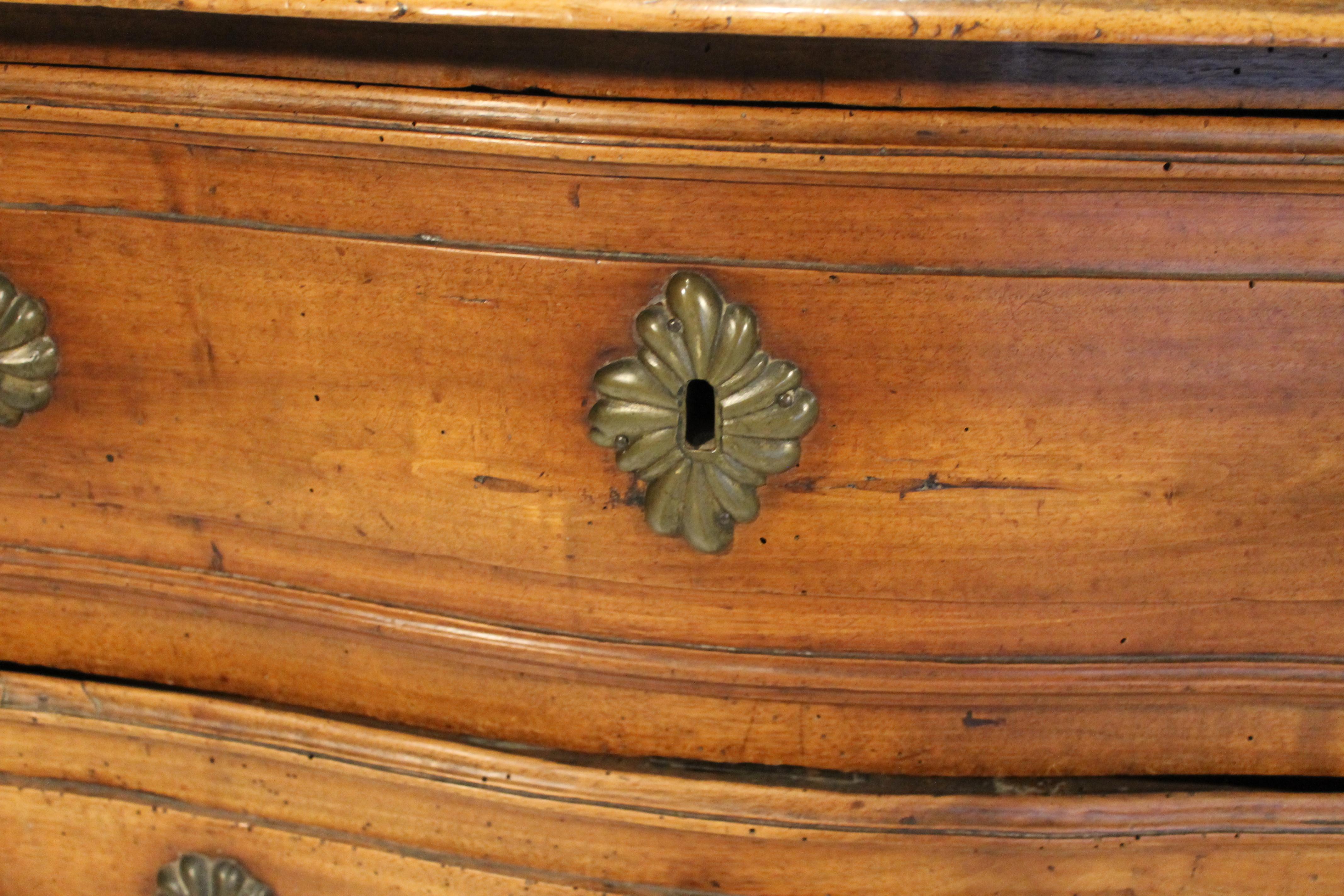 A stunning French Louis XV three drawer walnut commode in amazing condition. Each drawer has been Intricately carved with floral details and fitted with bronze hardware. The details on this amazing antique continue with cabriole feet and a