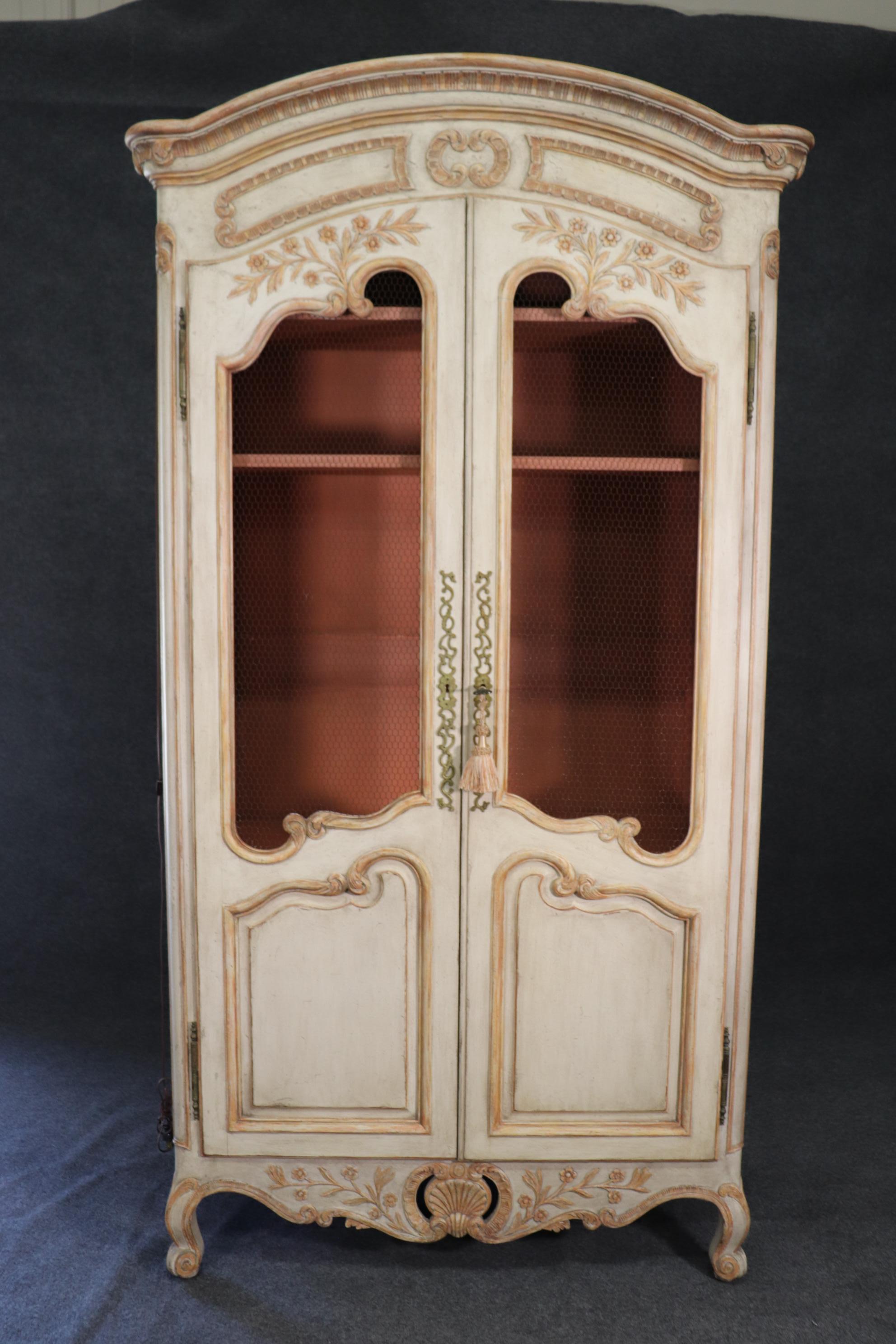 This is a charming piece with an equally charming color combination. The armoire is fitted with drapery hangers for hanging rapes inside the mesh doors. The interior color is a pinkish-coral. It is currently lighted. Measures 90 tall x 44 wide x 20