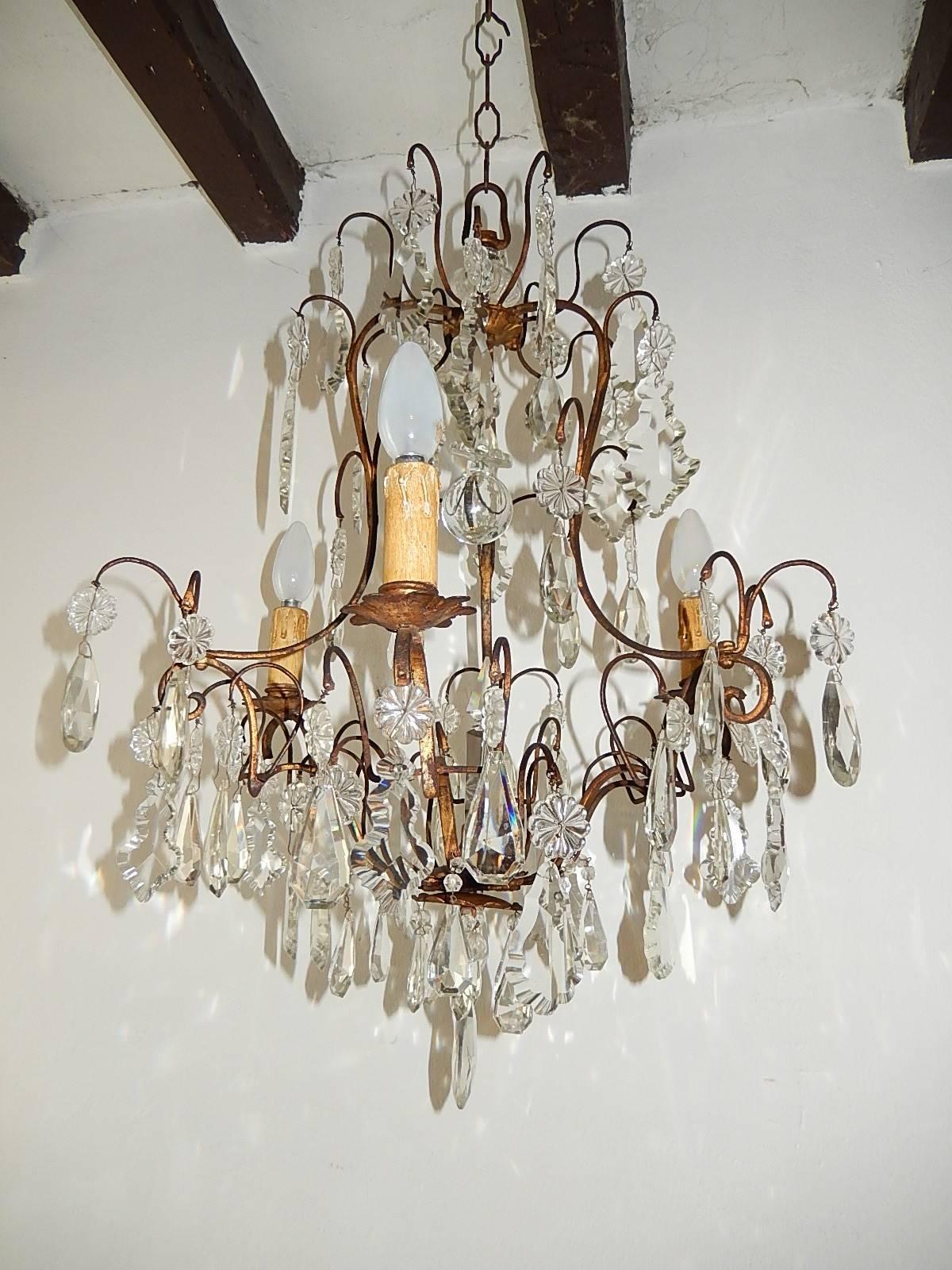 Housing three lights. Re-wired and ready to hang. Gilt metal with florets and crystal prisms. Crystal spear and ball in centre. Murano glass on top. Free priority shipping from Italy.