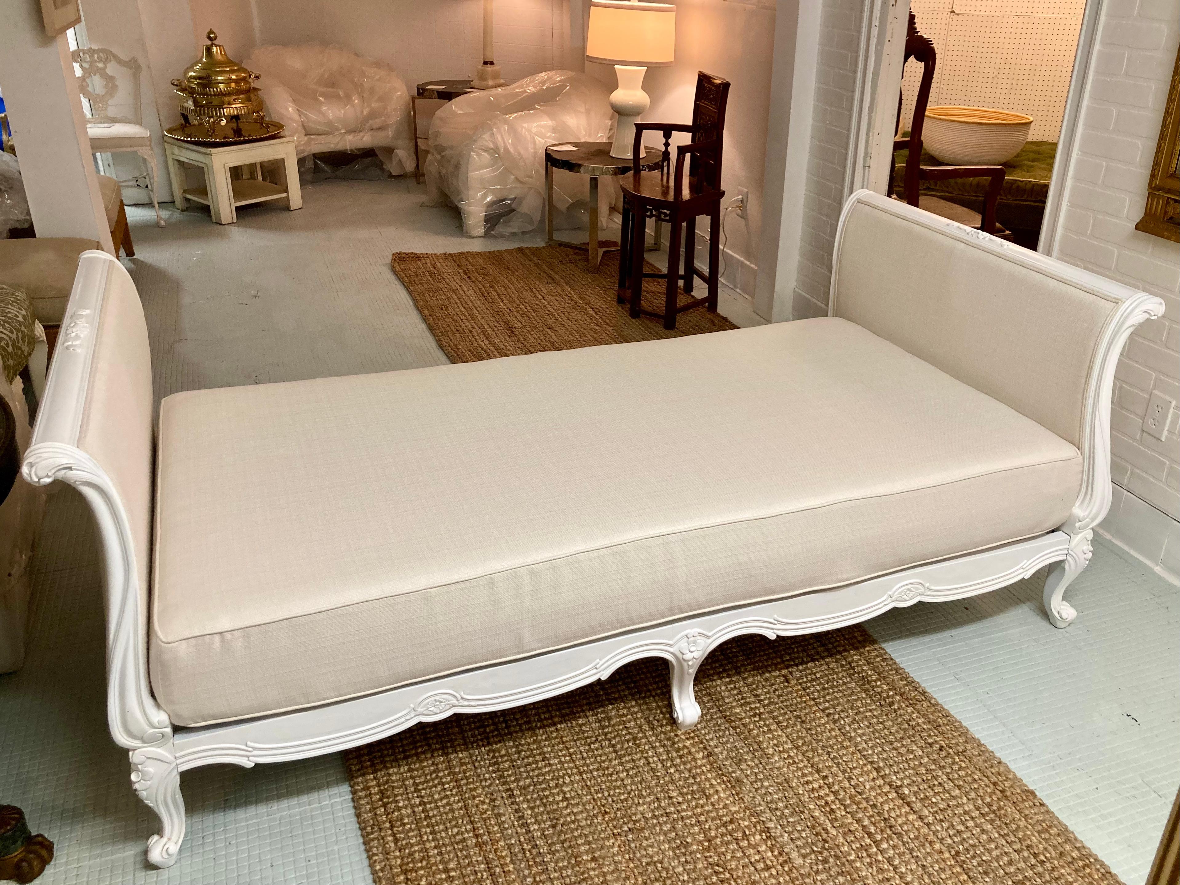 Beautiful French Louis XV daybed freshly lacquered in white with new Todd Hase upholstery high performance off-white. This daybed is fitted with an upholstered twin mattress and will accommodate and twin bedding and mattress type you desire. Add