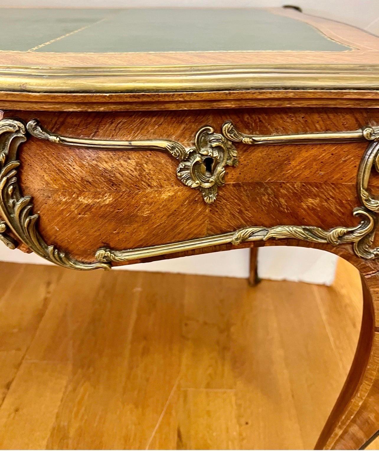 A magnificent antique fruitwood writing desk adorned in bronze and featuring a green leather top.  Made in France in the early 20th century.  Features three drawers at front.  A gorgeous addition to your home.  Why not own the best?
Protective
