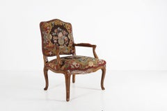 French Louis XV embroidered and carved armchair