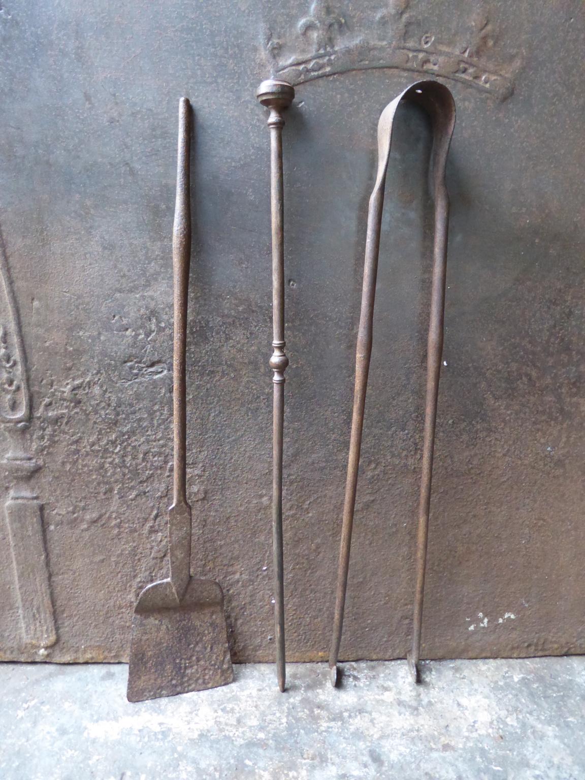 18th century French Louis XV fireplace tool set consisting of fireplace tongs, a poker and a shovel. The fire irons are made of wrought iron. They are in a good condition and are fully functional.