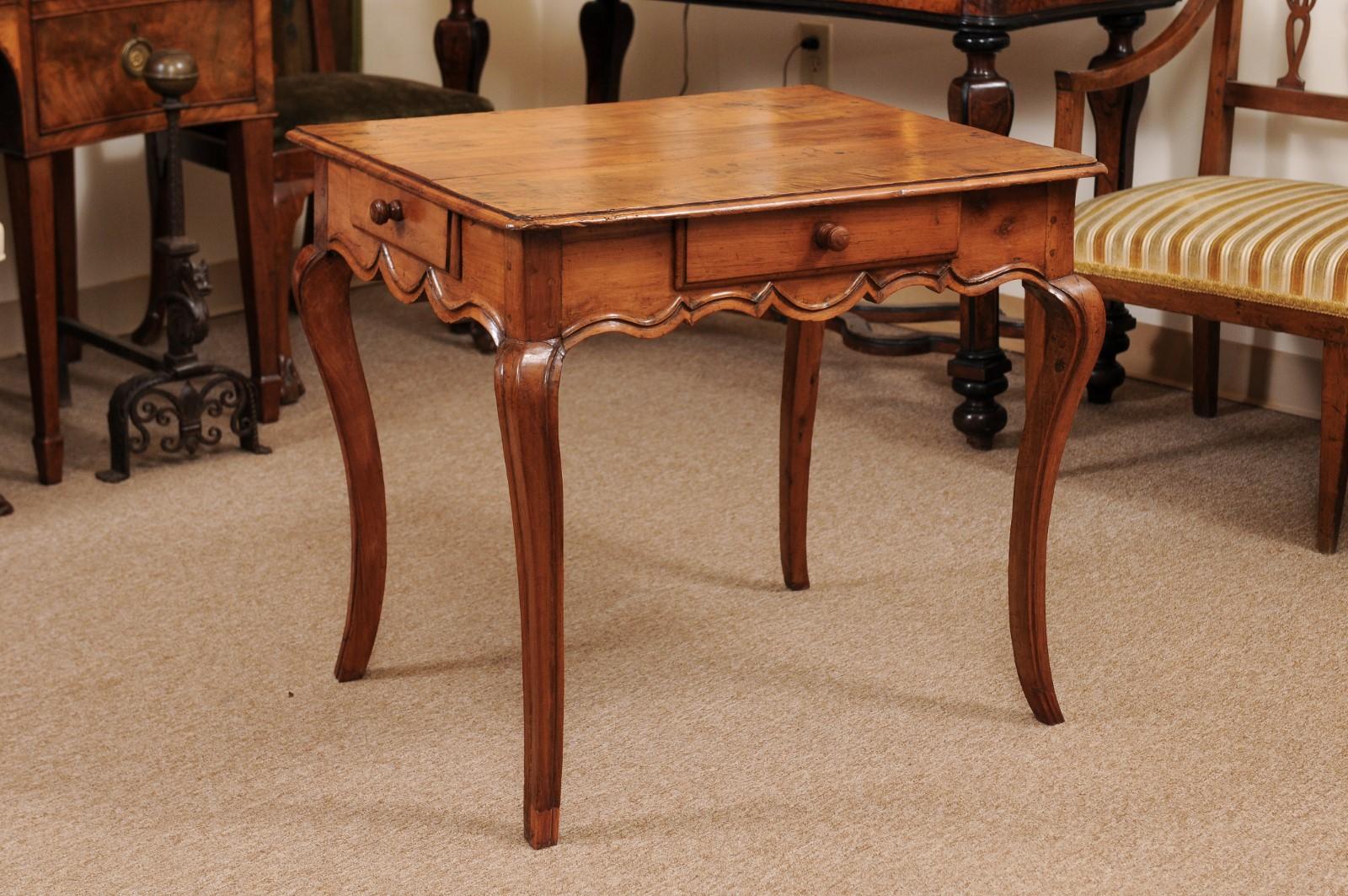 The French Louis XV fruitwood side with rectangular top, 2 drawers, shaped apron and cabriole legs. The table is finished on all sides.
 
  