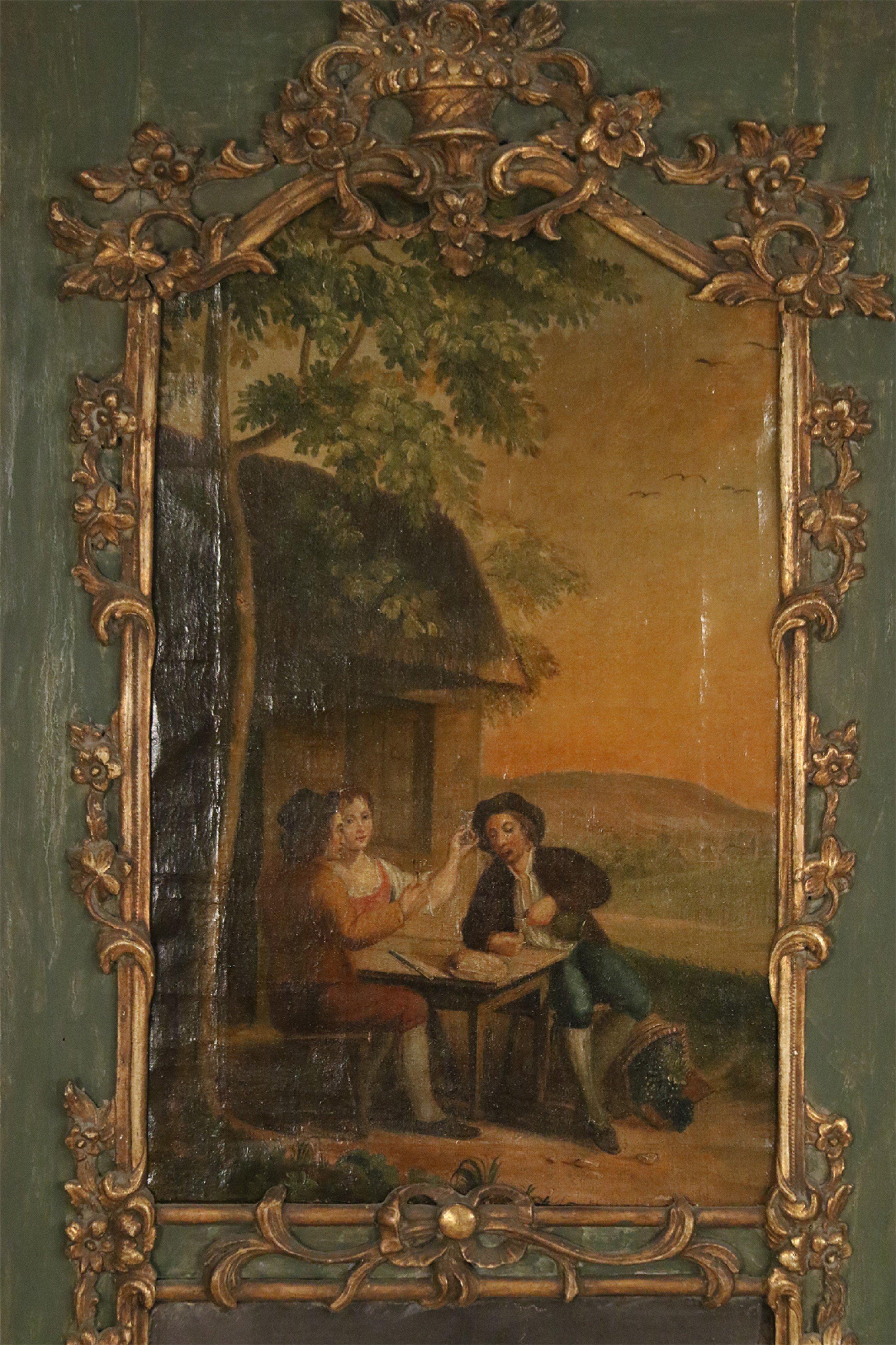 French Louis XV trumeau wall mirror with a painted scene of a family sitting at a table outside within an ornate giltwood frame on a green painted wooden back piece above a rectangular antique mirror.