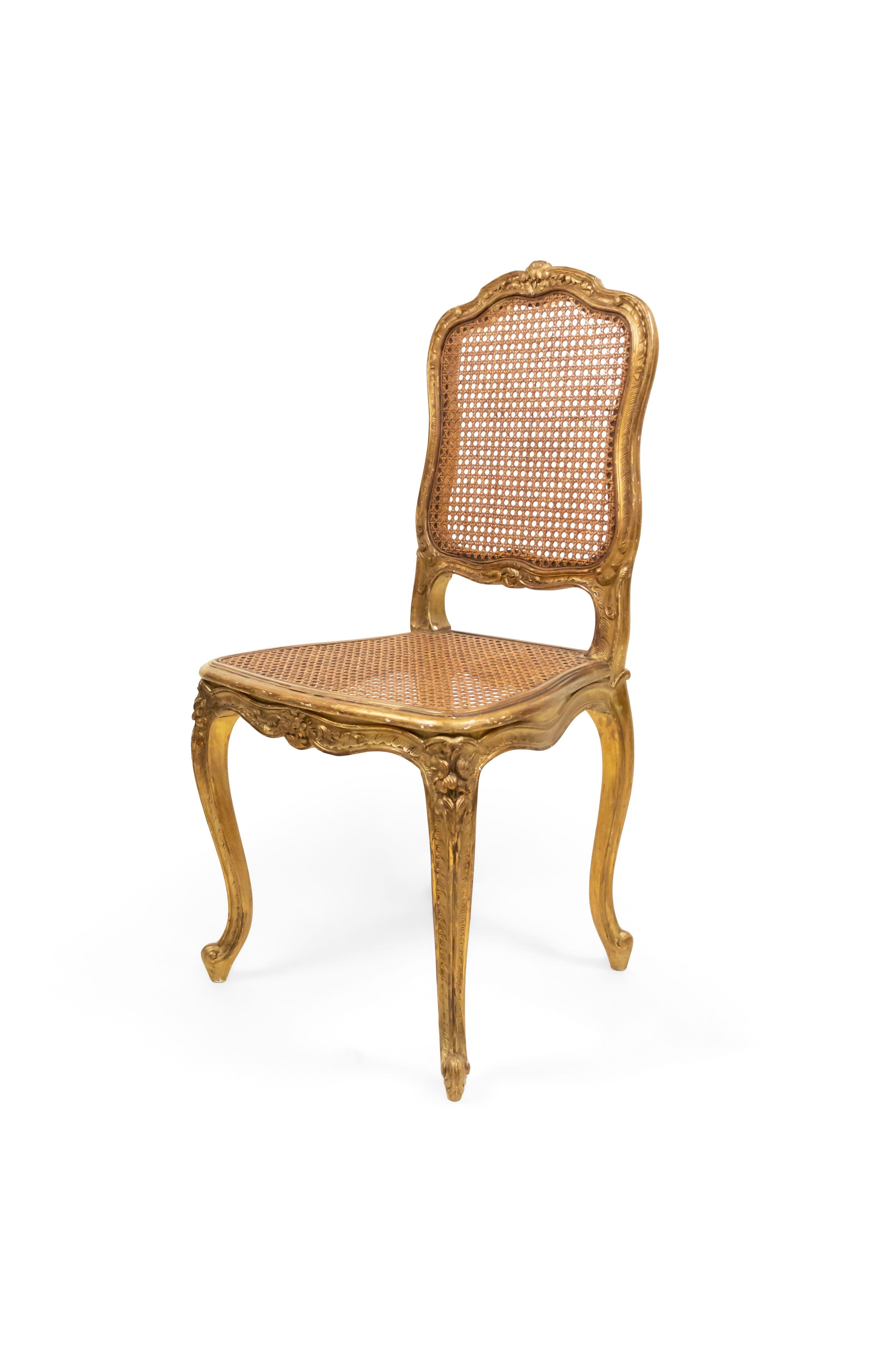 Set of 8 French Louis XV style (19th Century) gilt side chairs with cane seats.
