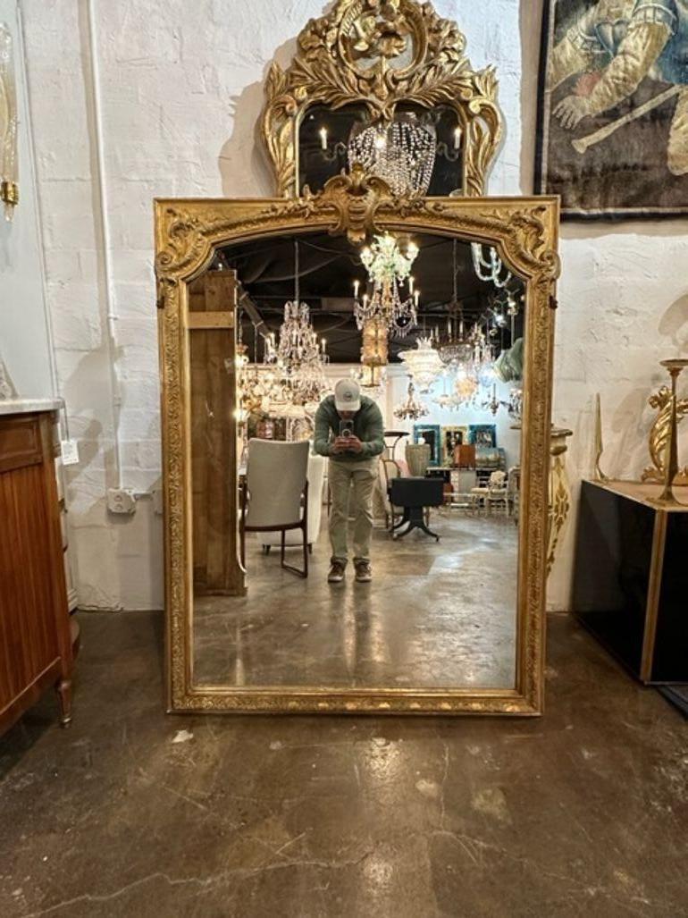 19th century French Louis XV giltwood mirror. Circa 1880. Adds warmth and charm to any room!