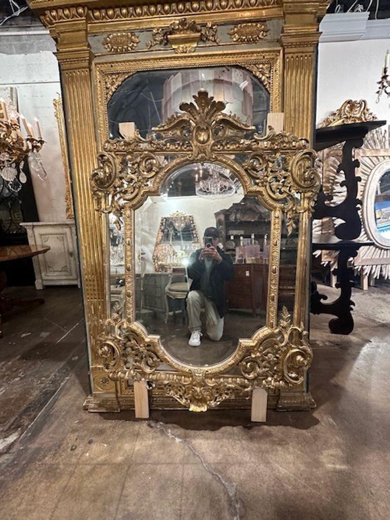 Gorgeous 19th century French Louis XV style carved and giltwood mirror. Circa 1860. This is an exceptional mirror and so pretty in person!