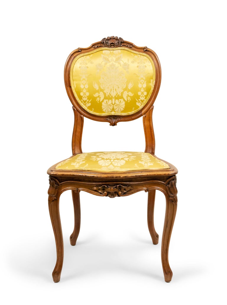 Set of 10 French Louis XV style walnut side chairs with gold damask upholstered seat and oval back (signed E. DELMAS) (19th century).