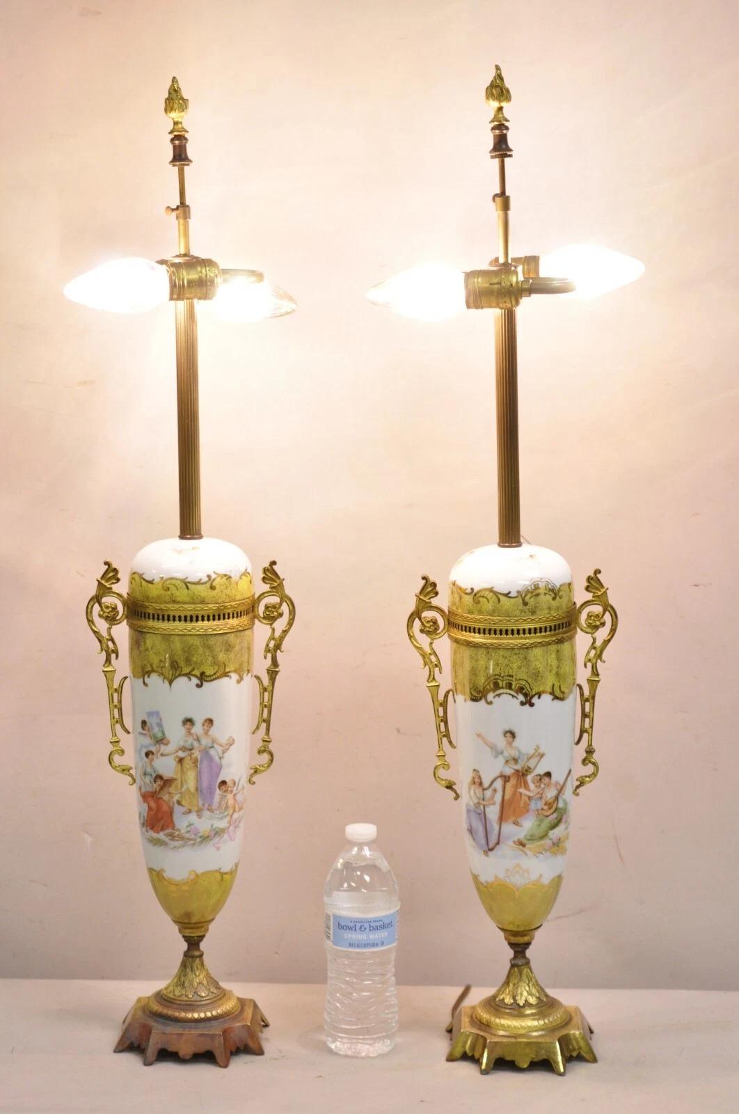 Antique French Louis XV Sevres Style Hand Painted Porcelain Women Musicians Bronze Ormolu Table Lamps - a Pair. Item features hand painted scenes to both sides of women musicians and cherubs and other gold gilt detail. Circa Early 20th Century.